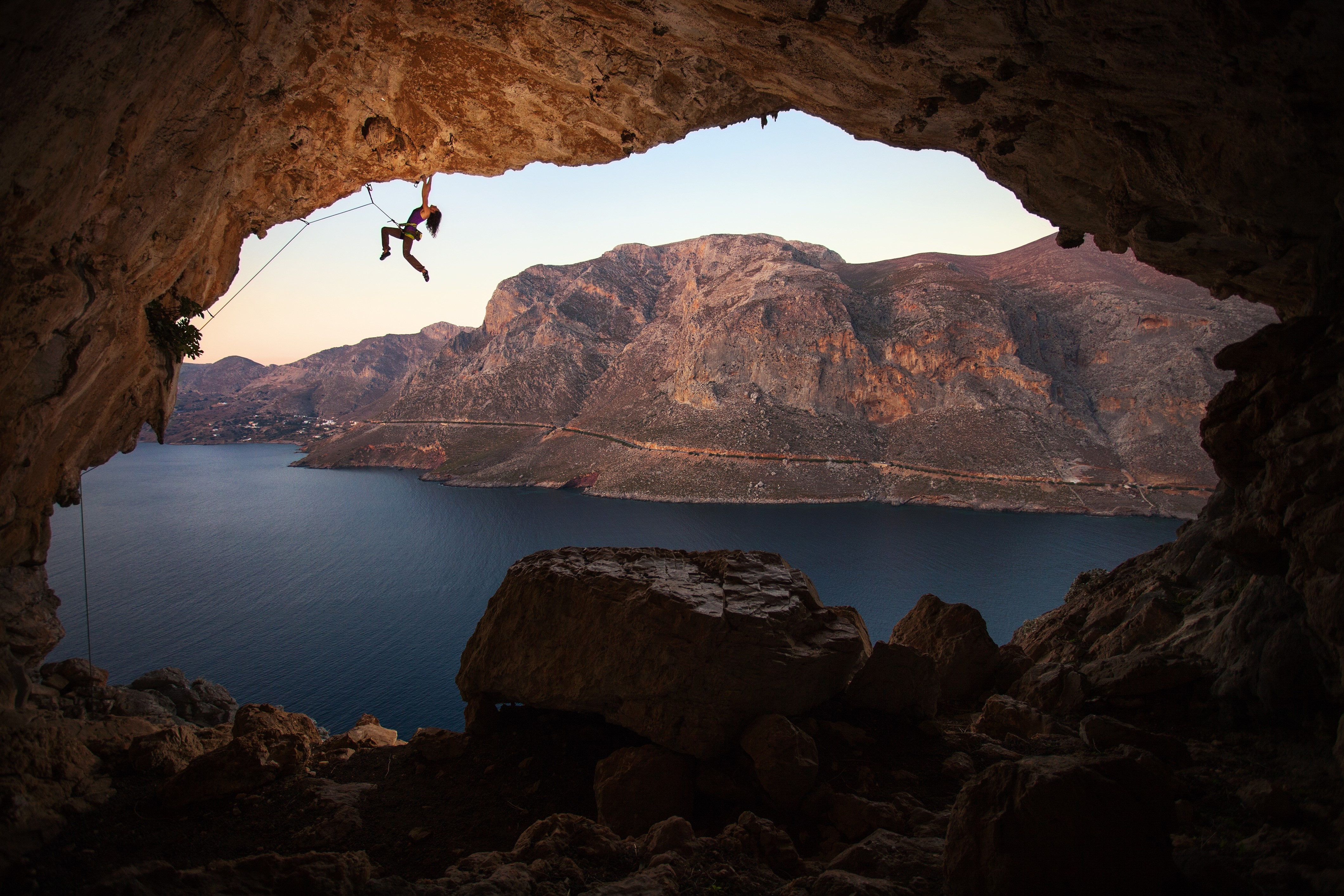 4K Climber in Cave overlooking Bay in Greece HD Wallpaper
