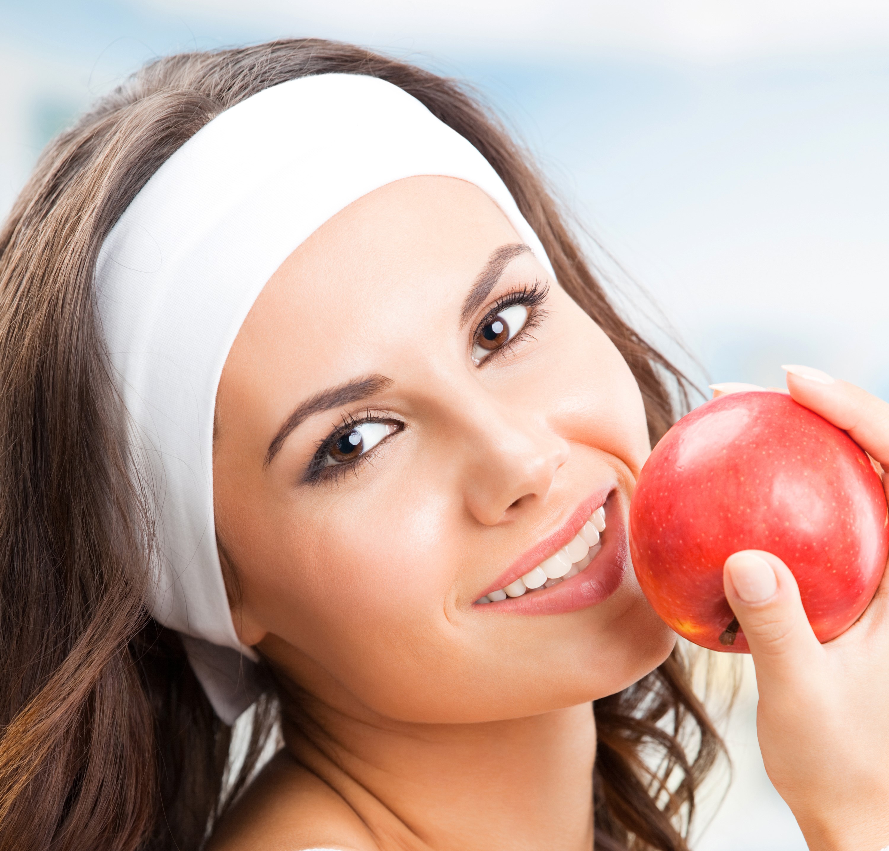 Woman with headband holding a red apple HD Wallpaper