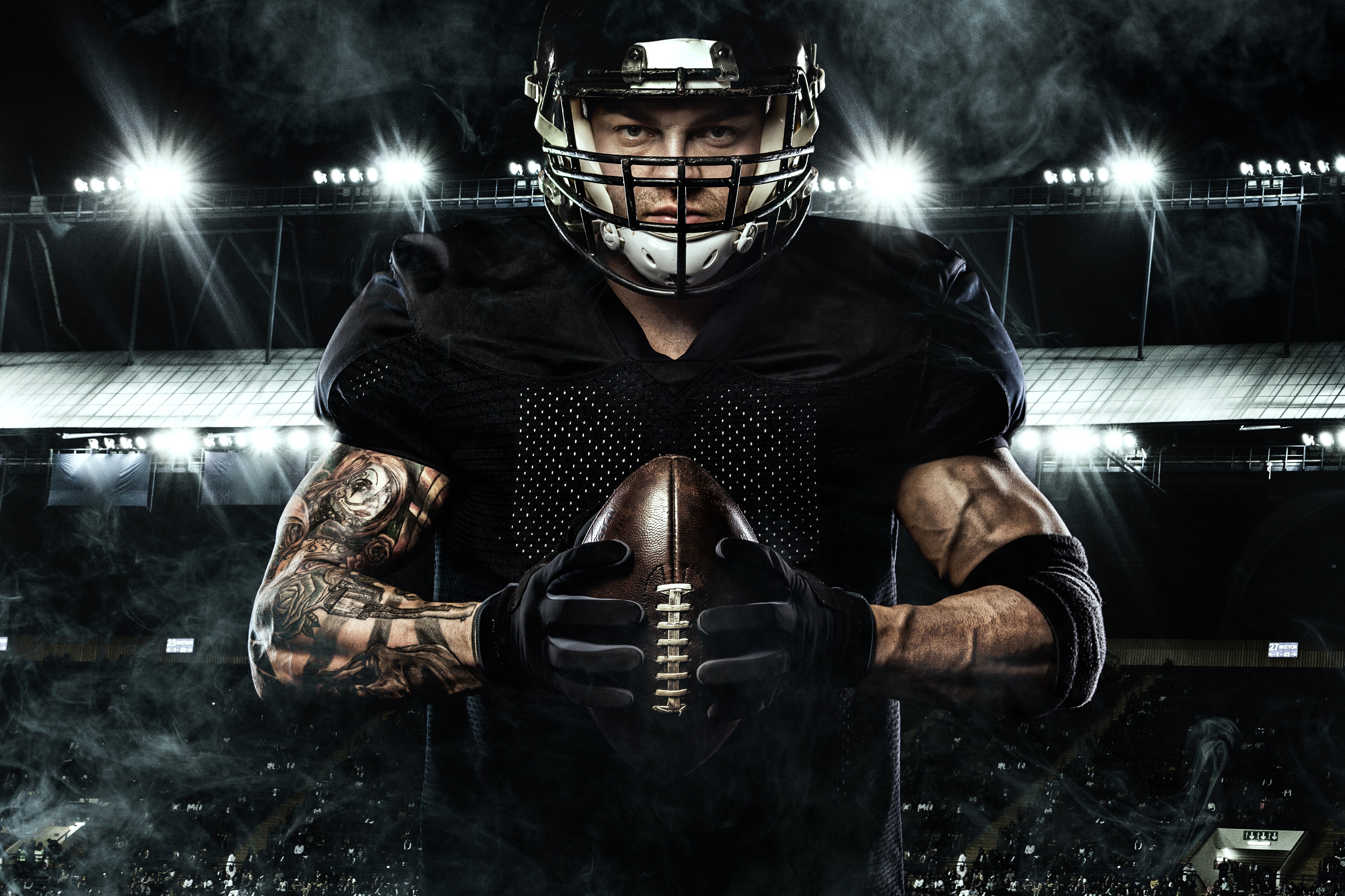 American football player holding a ball HD Wallpaper