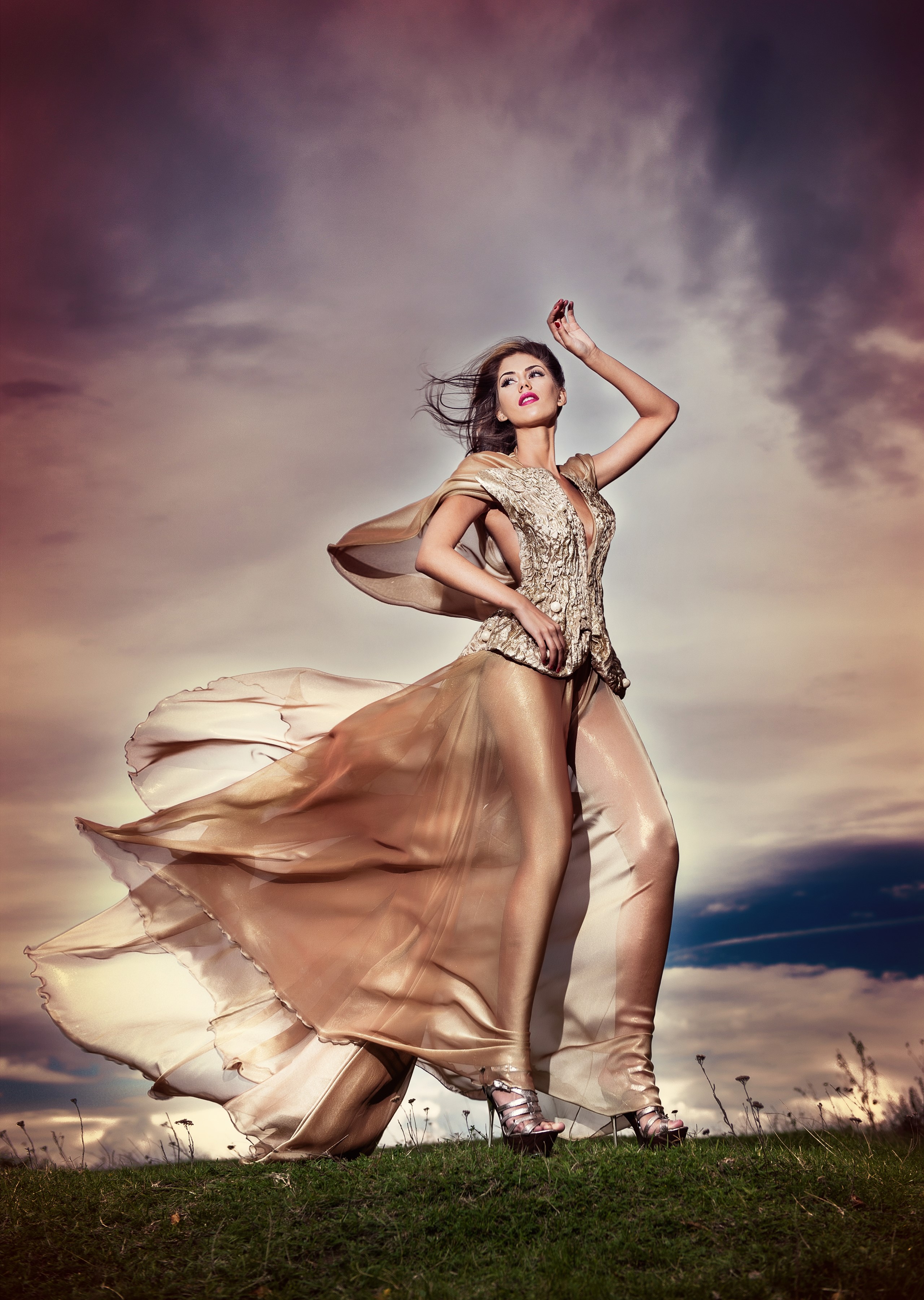 Woman in a flowing golden dress on a grassy hill HD Phone Wallpaper