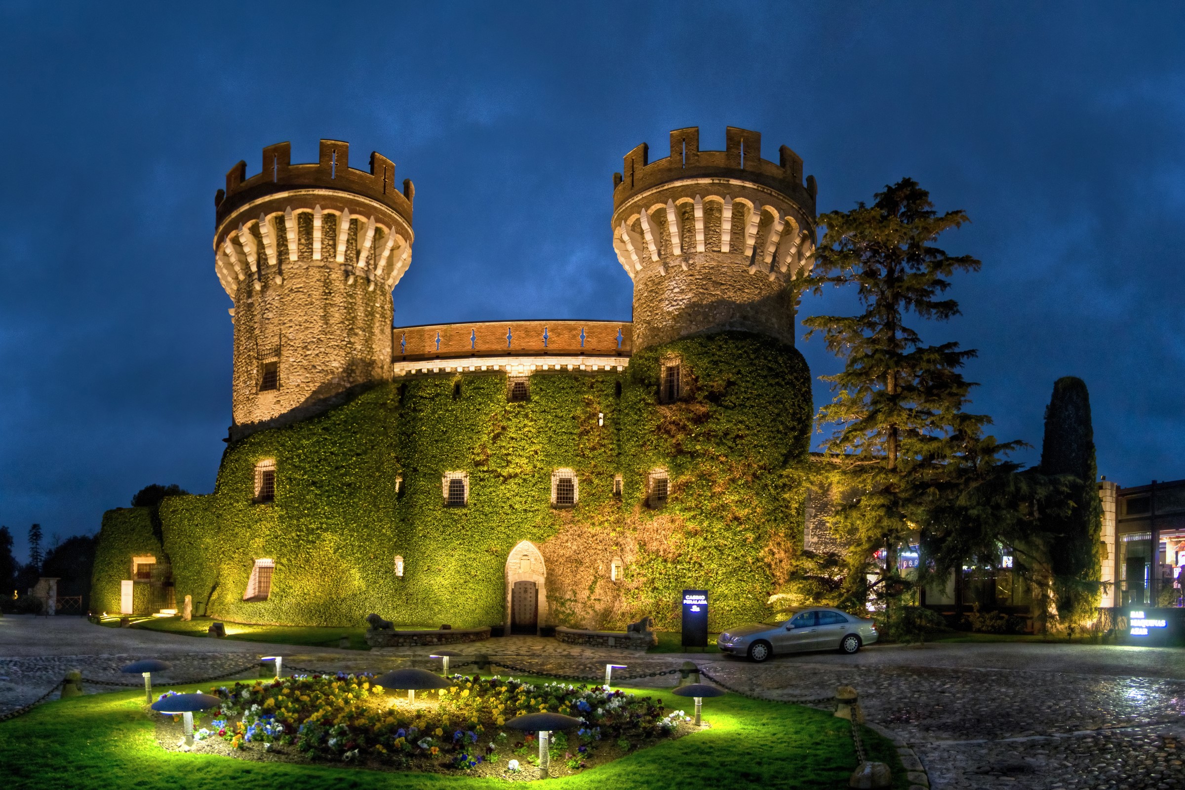 Castell Peralada castle at night with ivy and lights HD Wallpaper