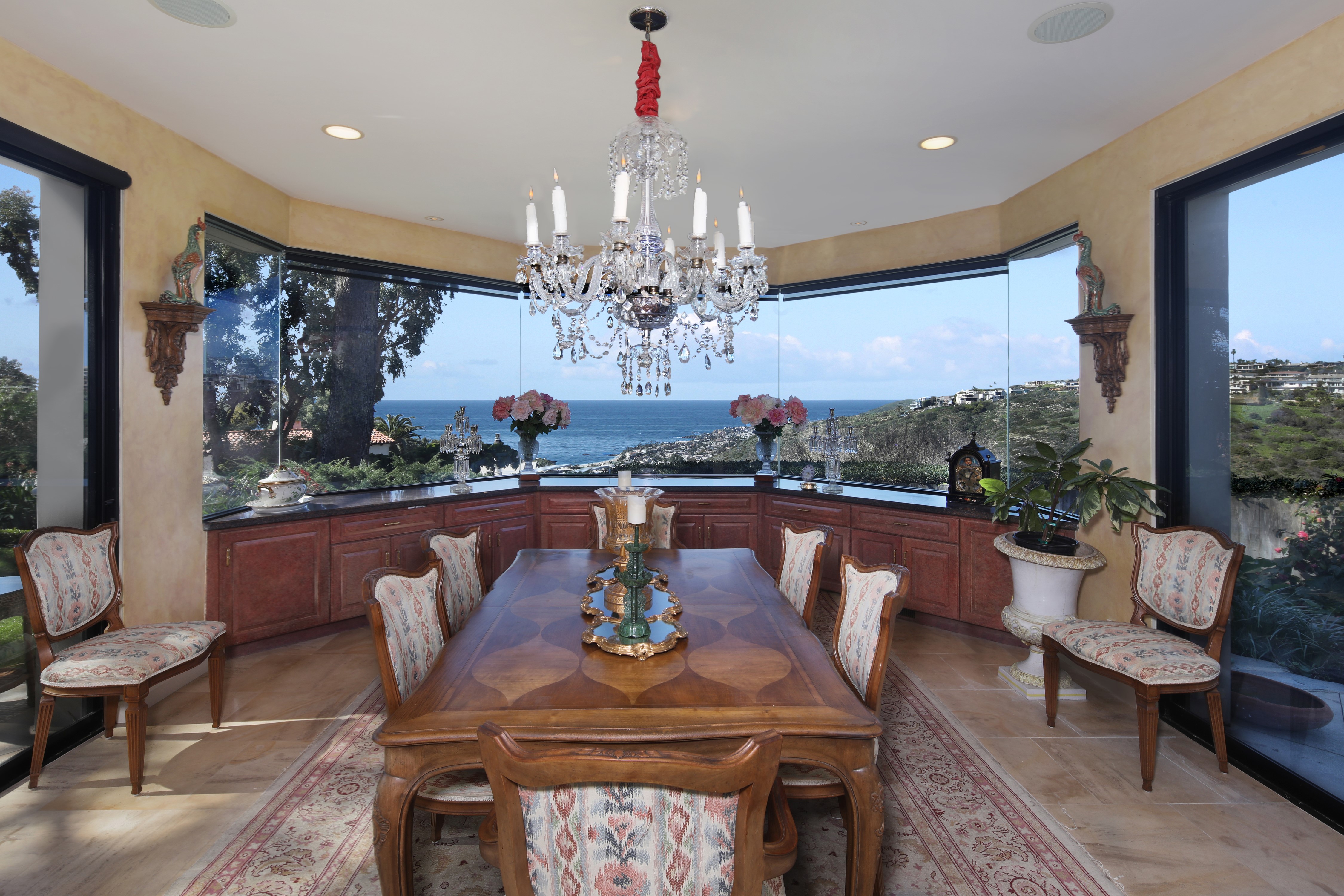 Dining room with ocean view and chandelier HD Wallpaper
