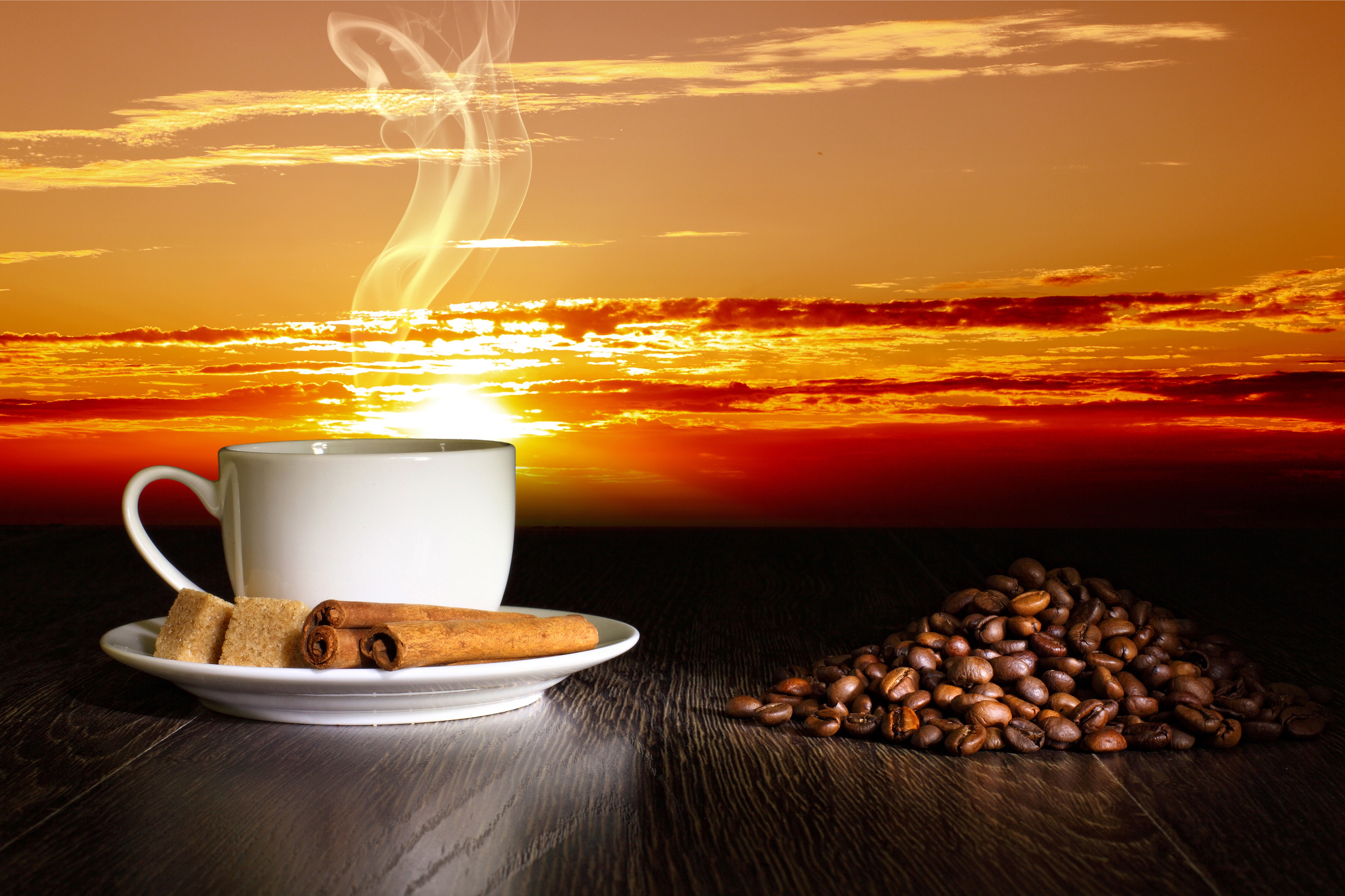 Coffee cup with sugar and cinnamon sticks at sunset HD Wallpaper