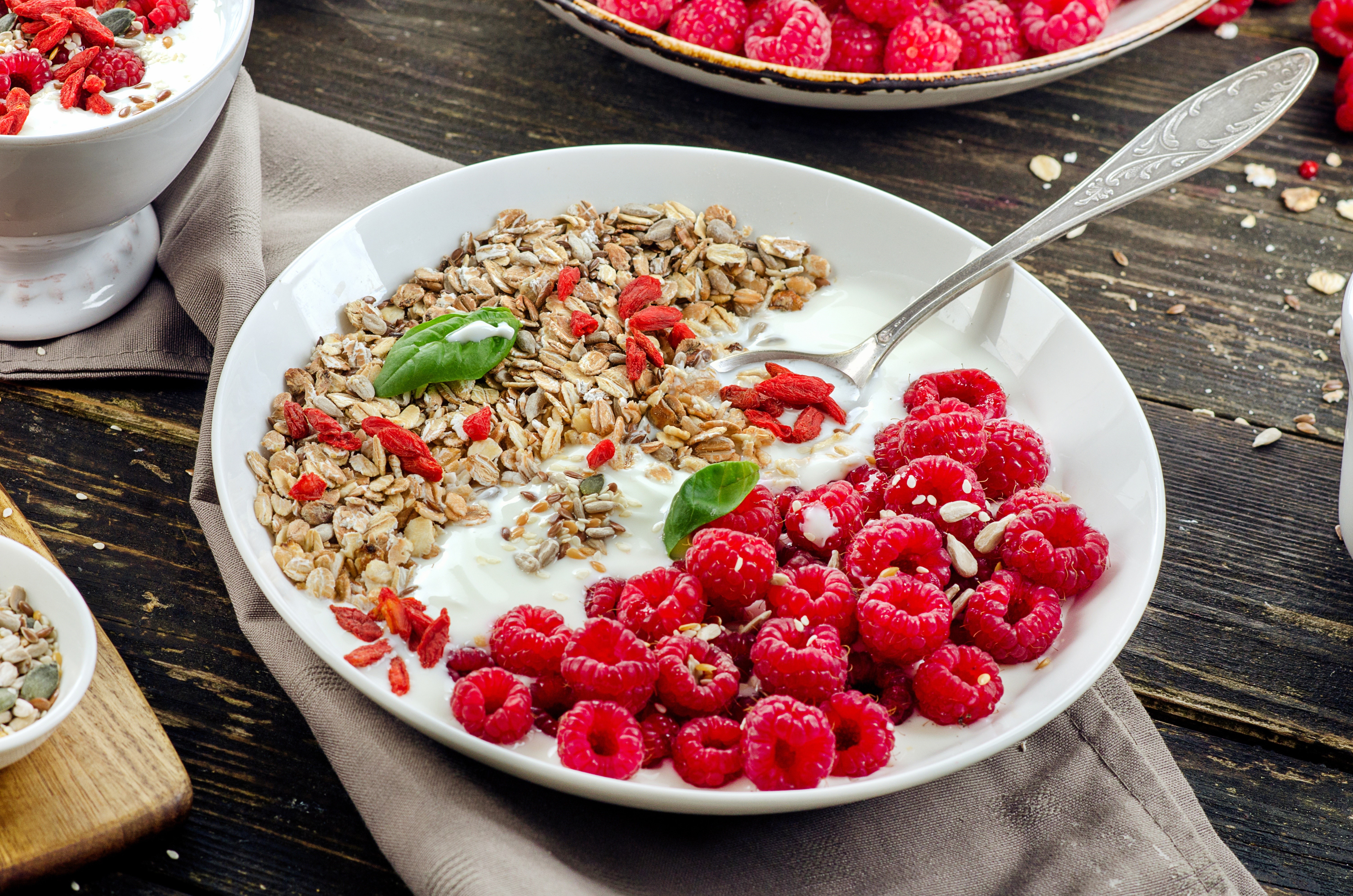 Muesli with raspberries and yogurt on a plate with a spoon HD Wallpaper