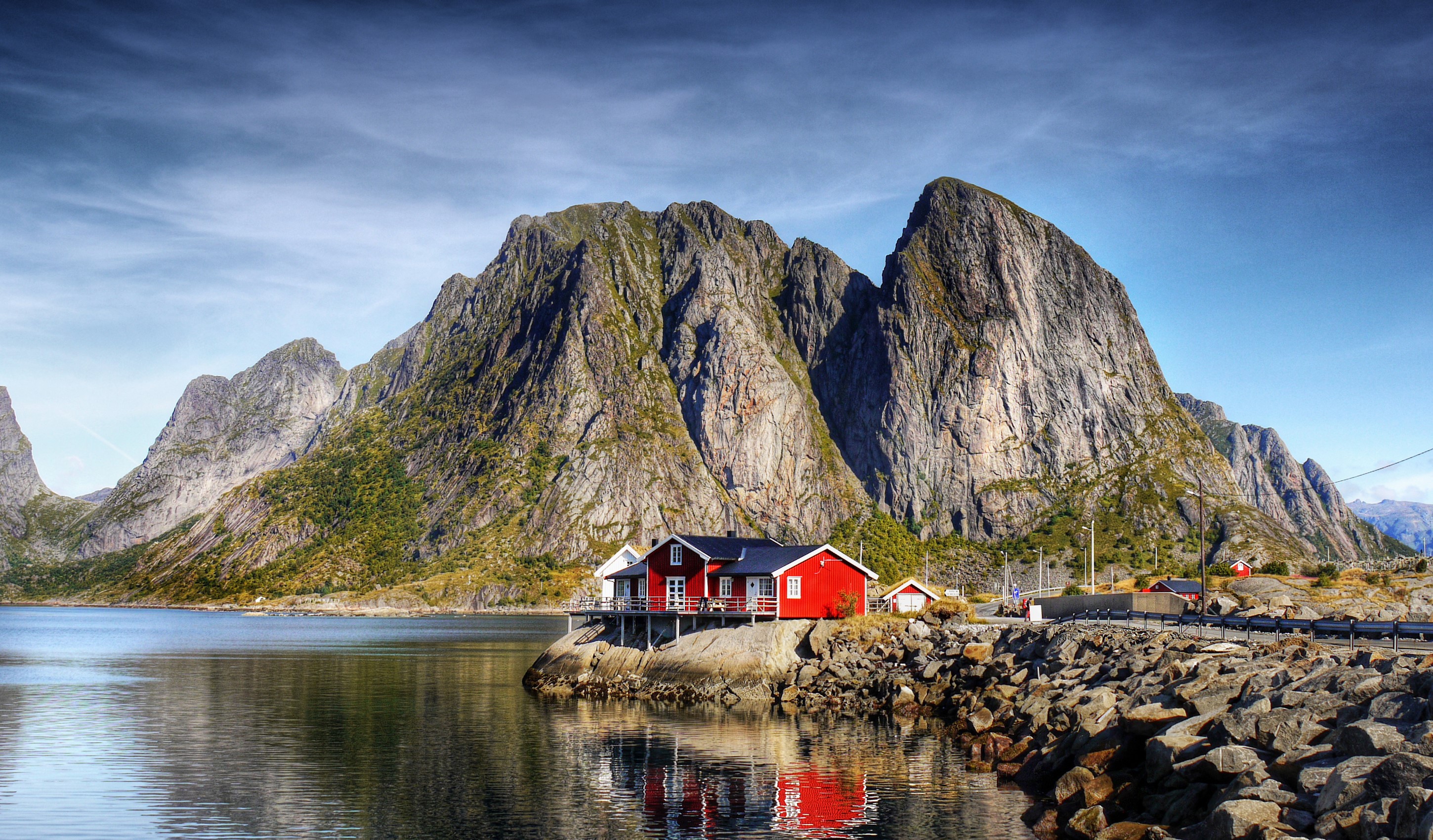 Red houses on a rocky shore with mountains in Lofoten, Norway HD Wallpaper
