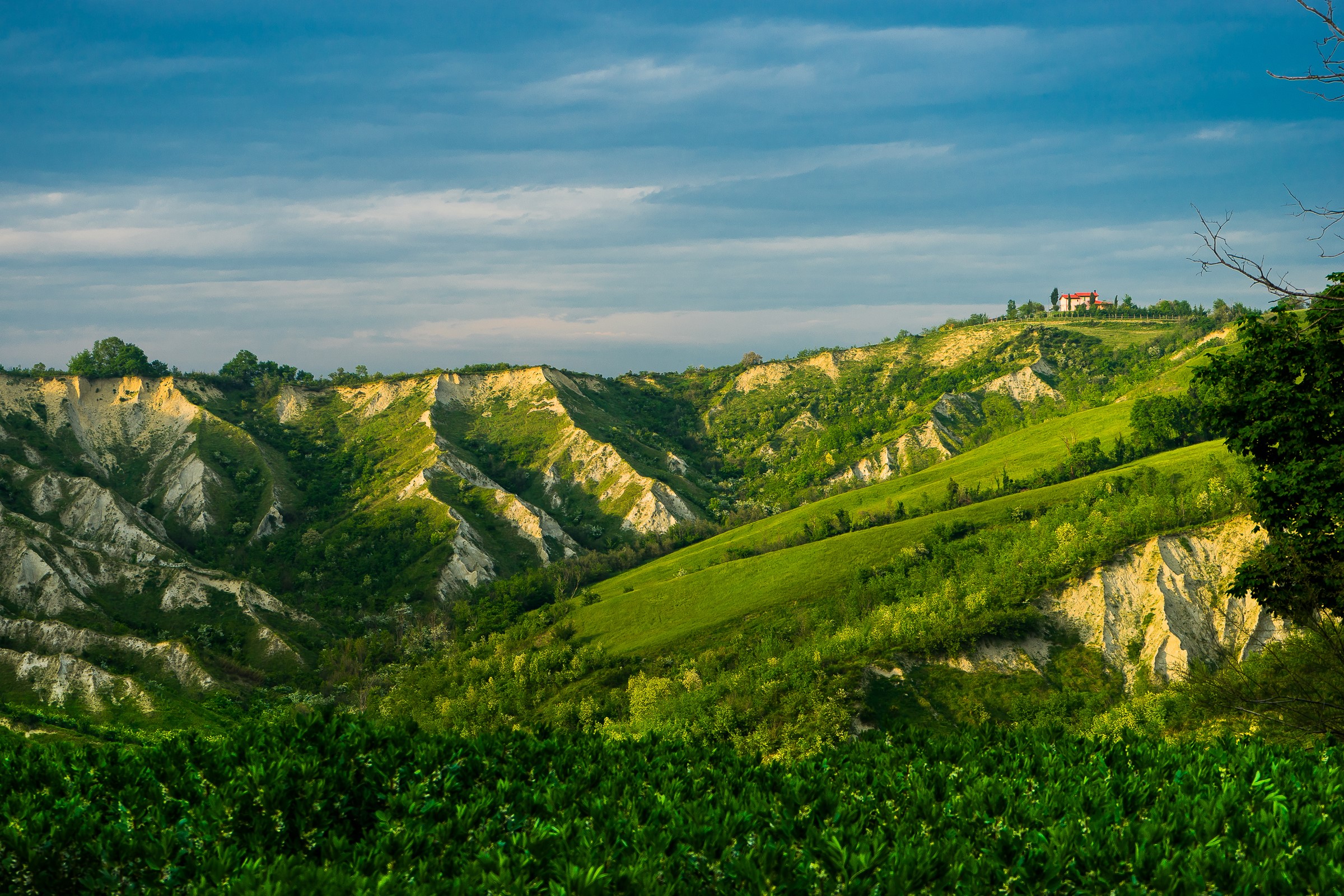 Rolling green hills and eroded landscape in Brisighella, Italy HD Wallpaper