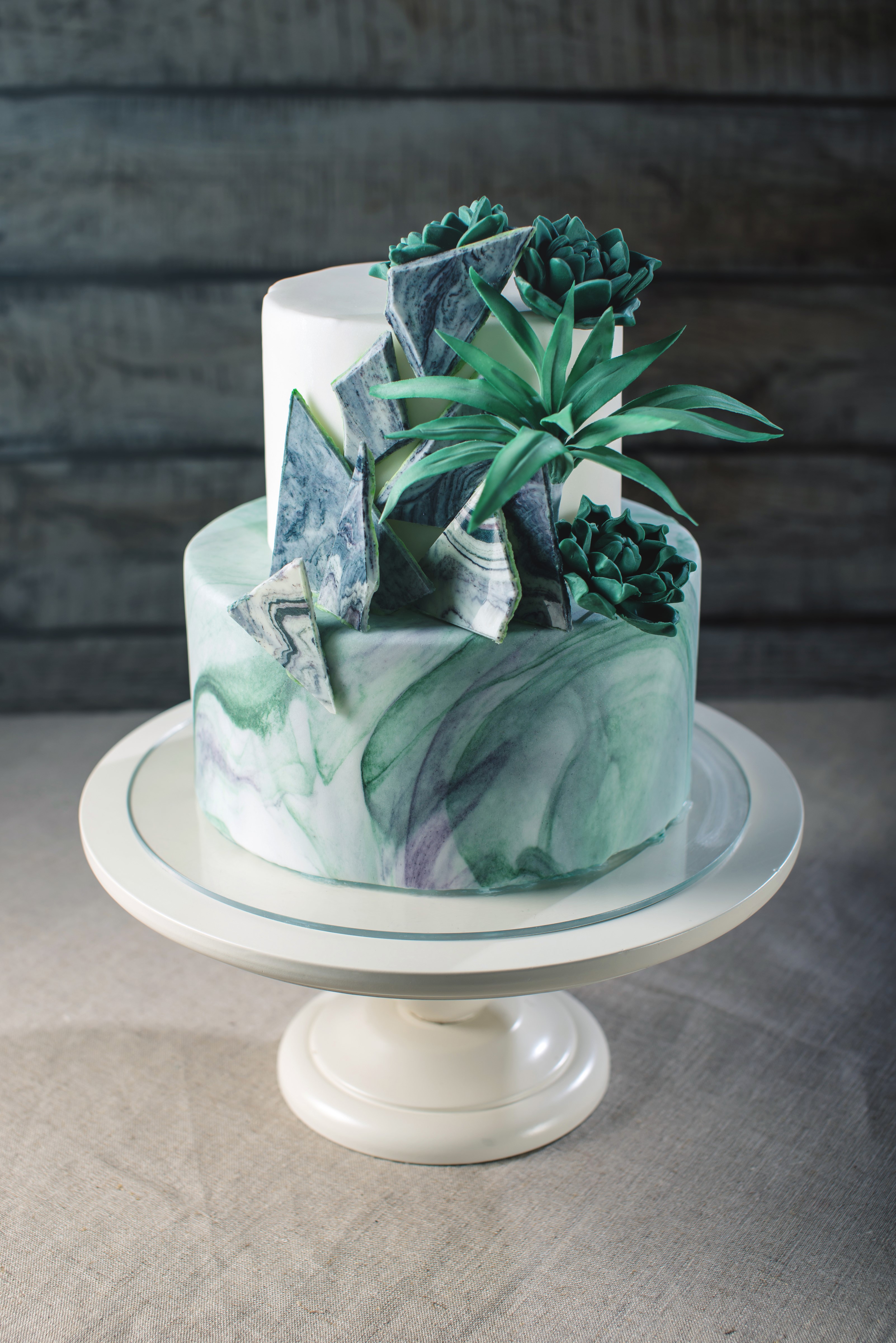 Two-tiered cake with marble design and succulents HD Phone Wallpaper