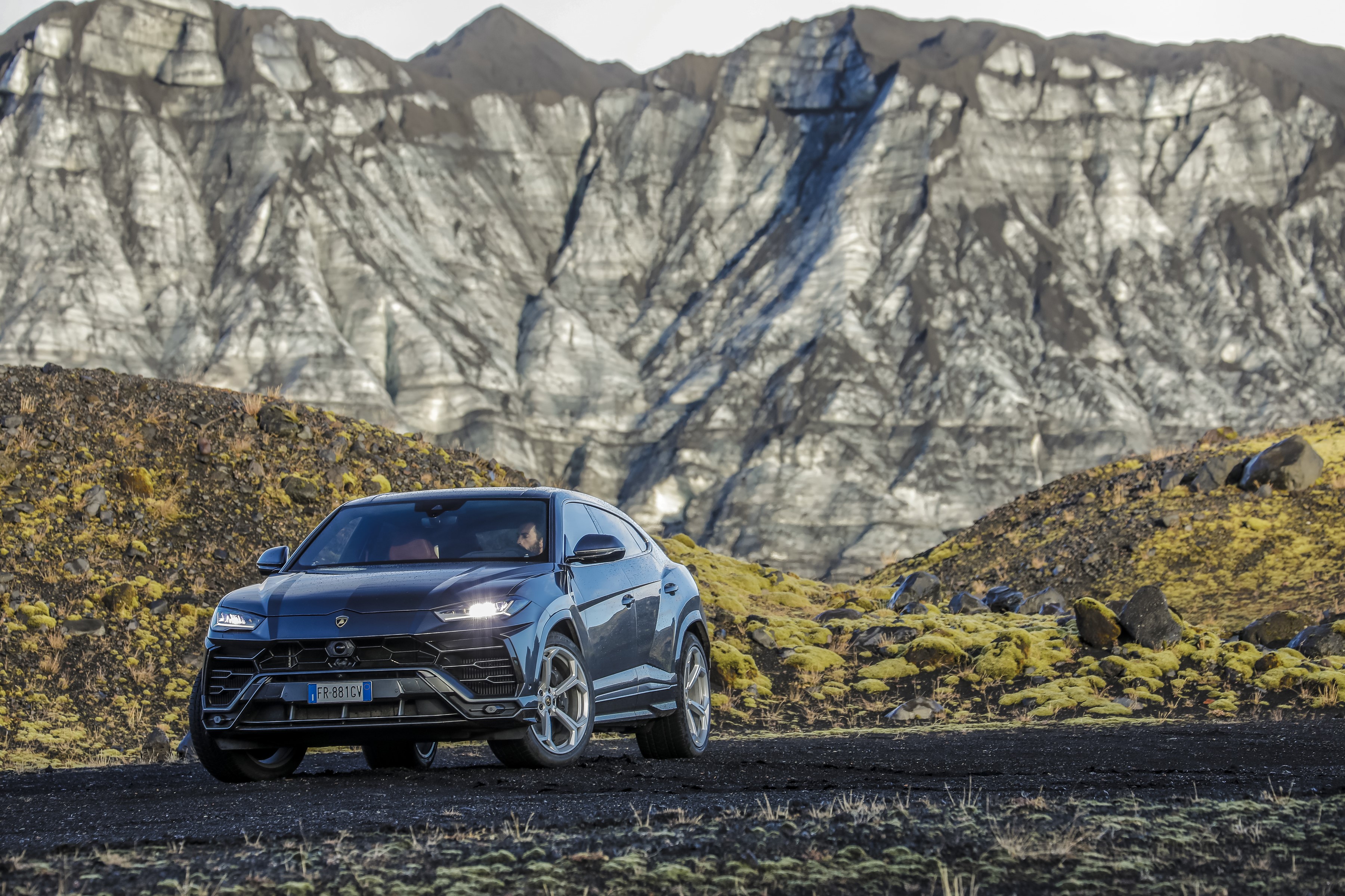 Lamborghini Urus in a rocky, mountainous landscape HD Wallpaper