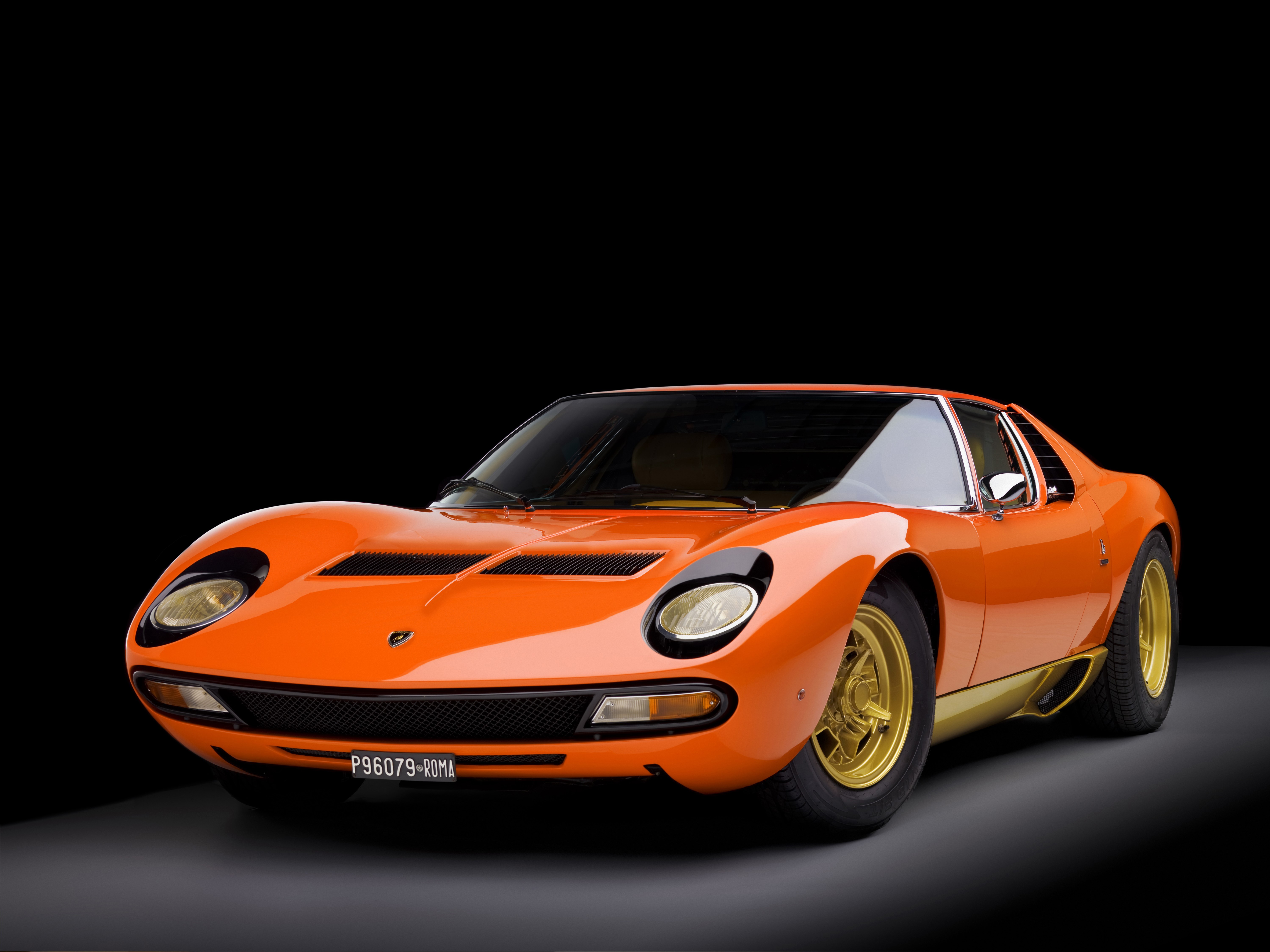 Orange Lamborghini Miura P400 SV Bertone on black background HD Wallpaper