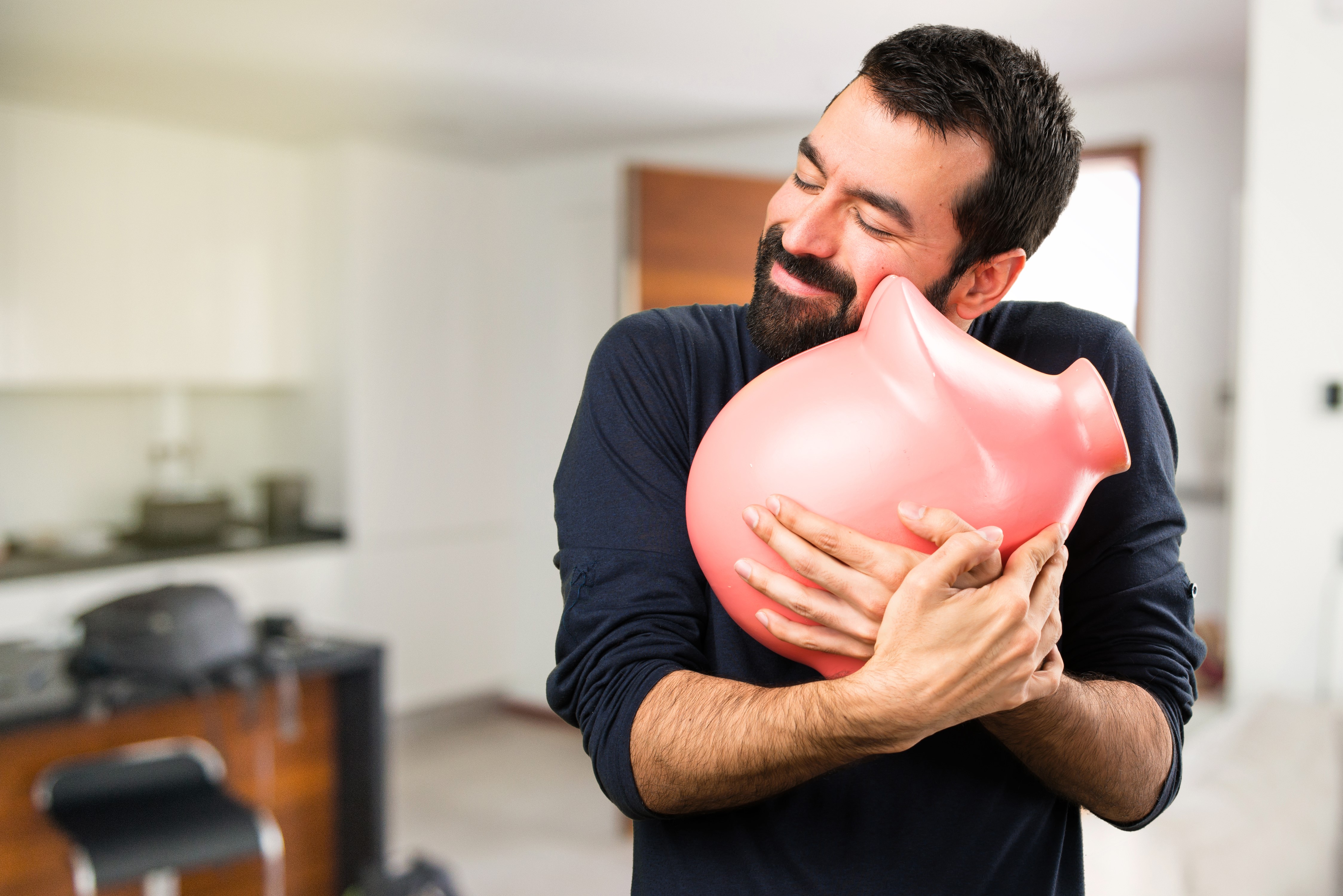 Man hugging a pink piggy bank HD Wallpaper