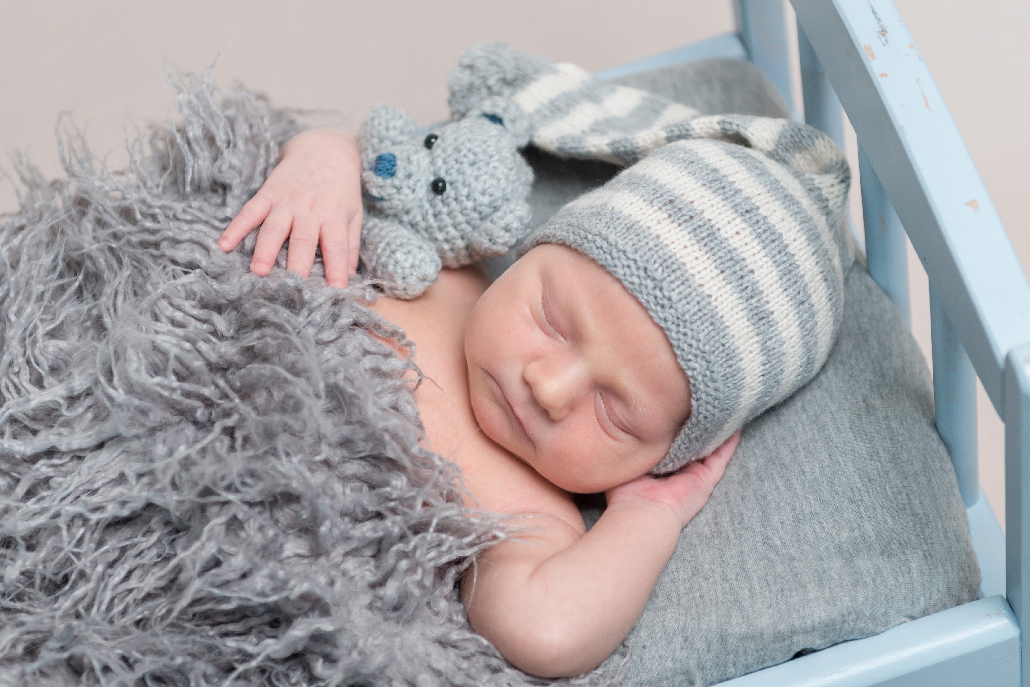 Newborn baby sleeping with teddy bear and winter hat HD Wallpaper