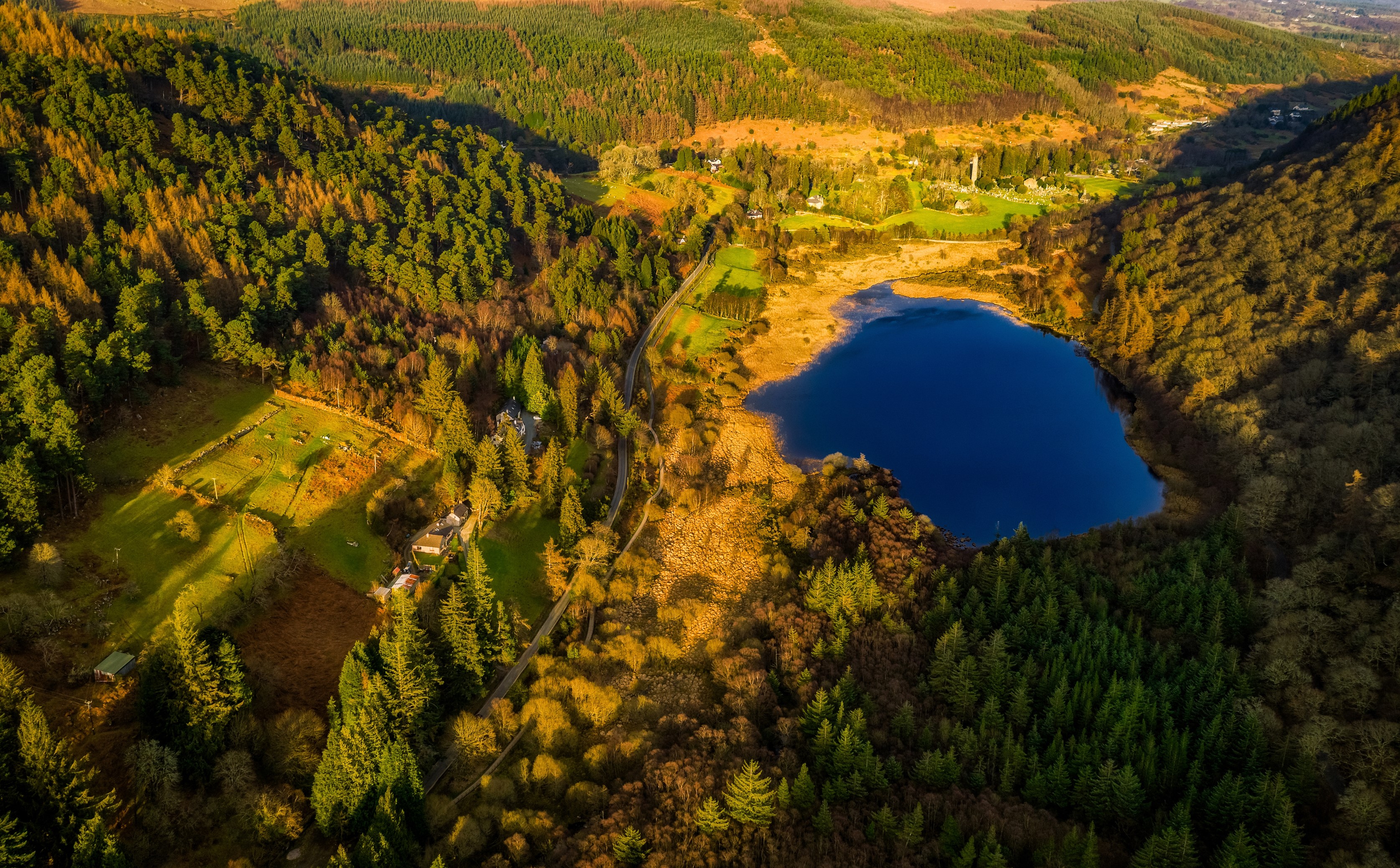 Aerial view of Glendalough lake and forests in Wicklow Mountains National Park, Ireland HD Wallpaper