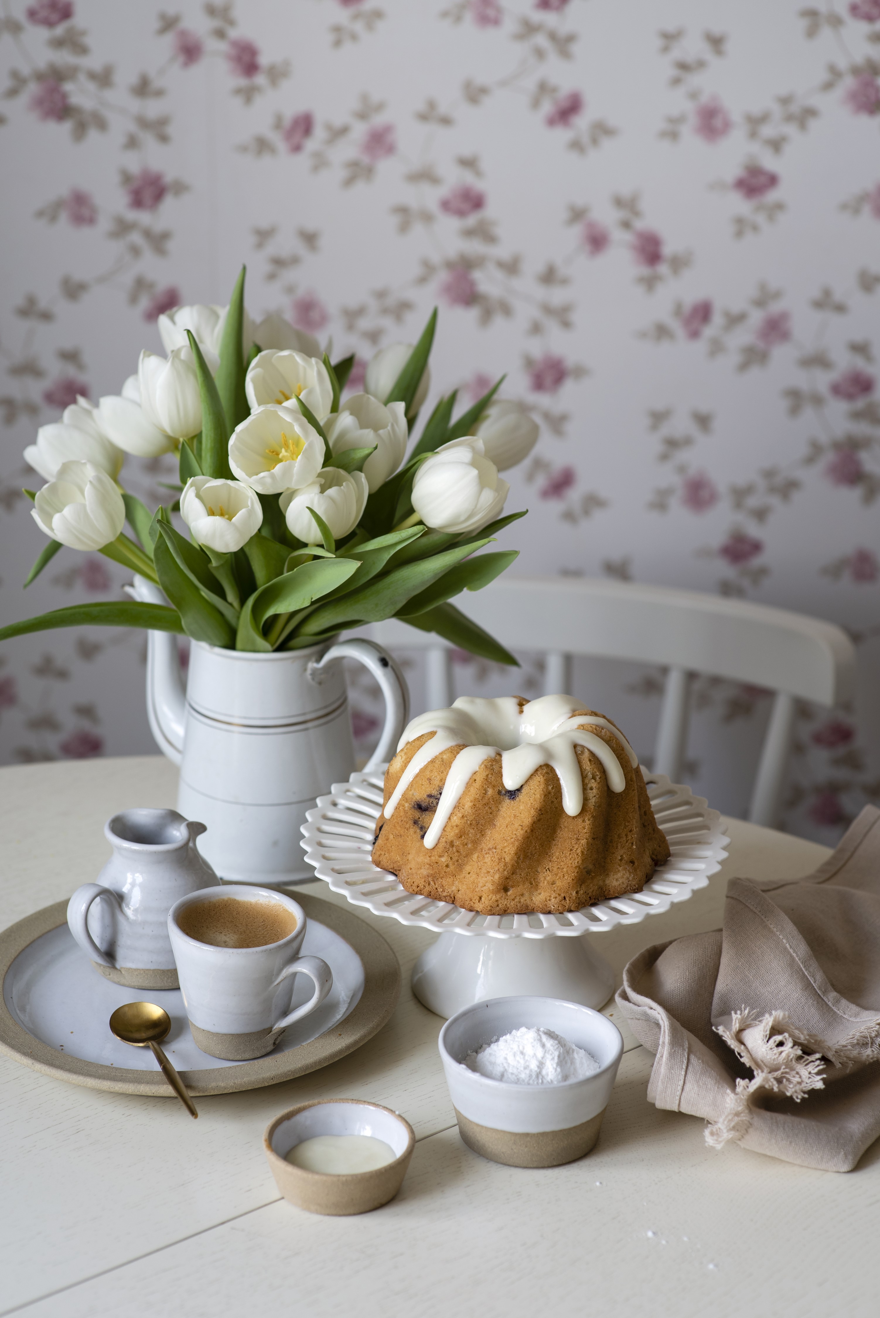 Bundt cake with white icing, tulips, and coffee HD Phone Wallpaper