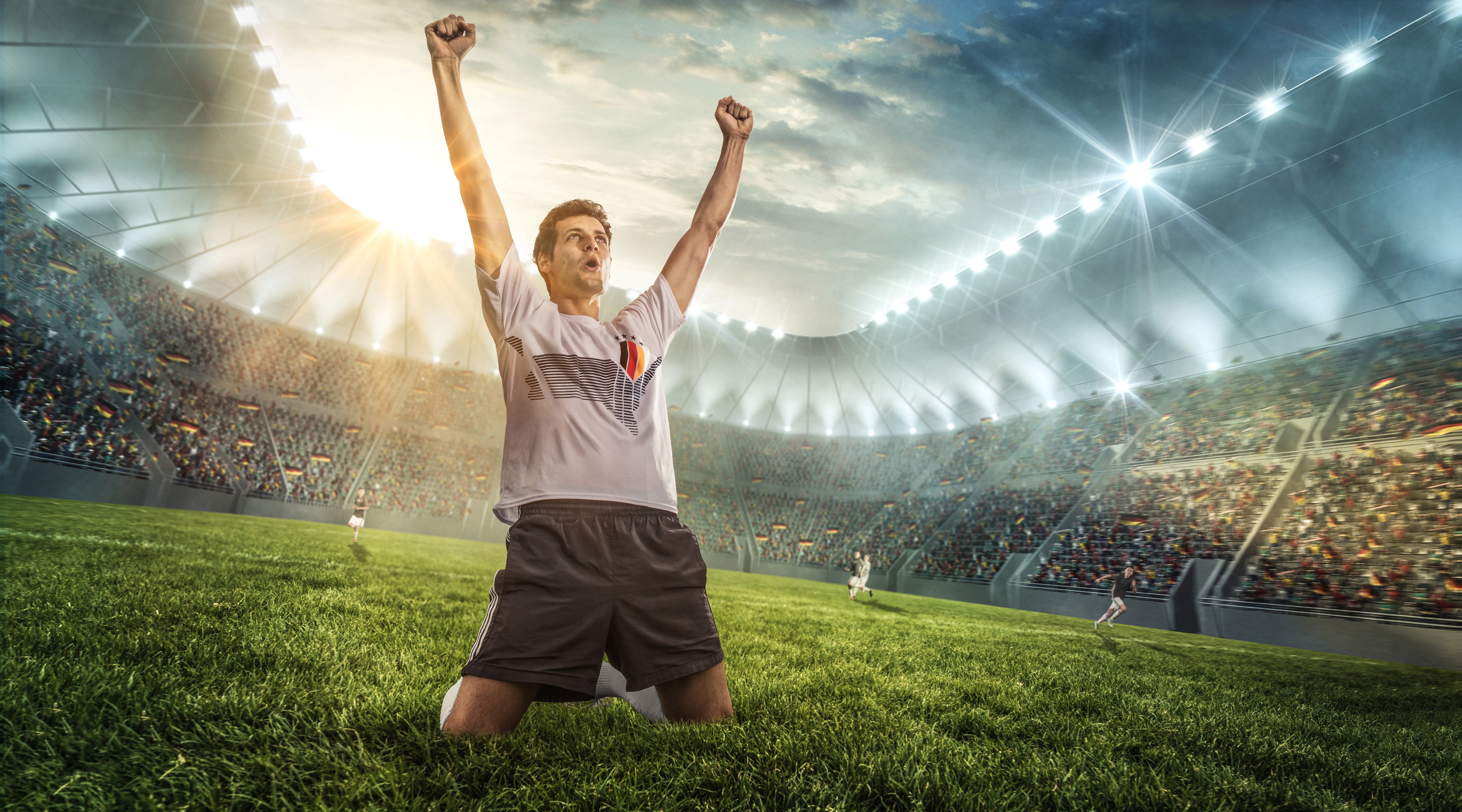 Soccer player celebrating a goal in a stadium HD Wallpaper