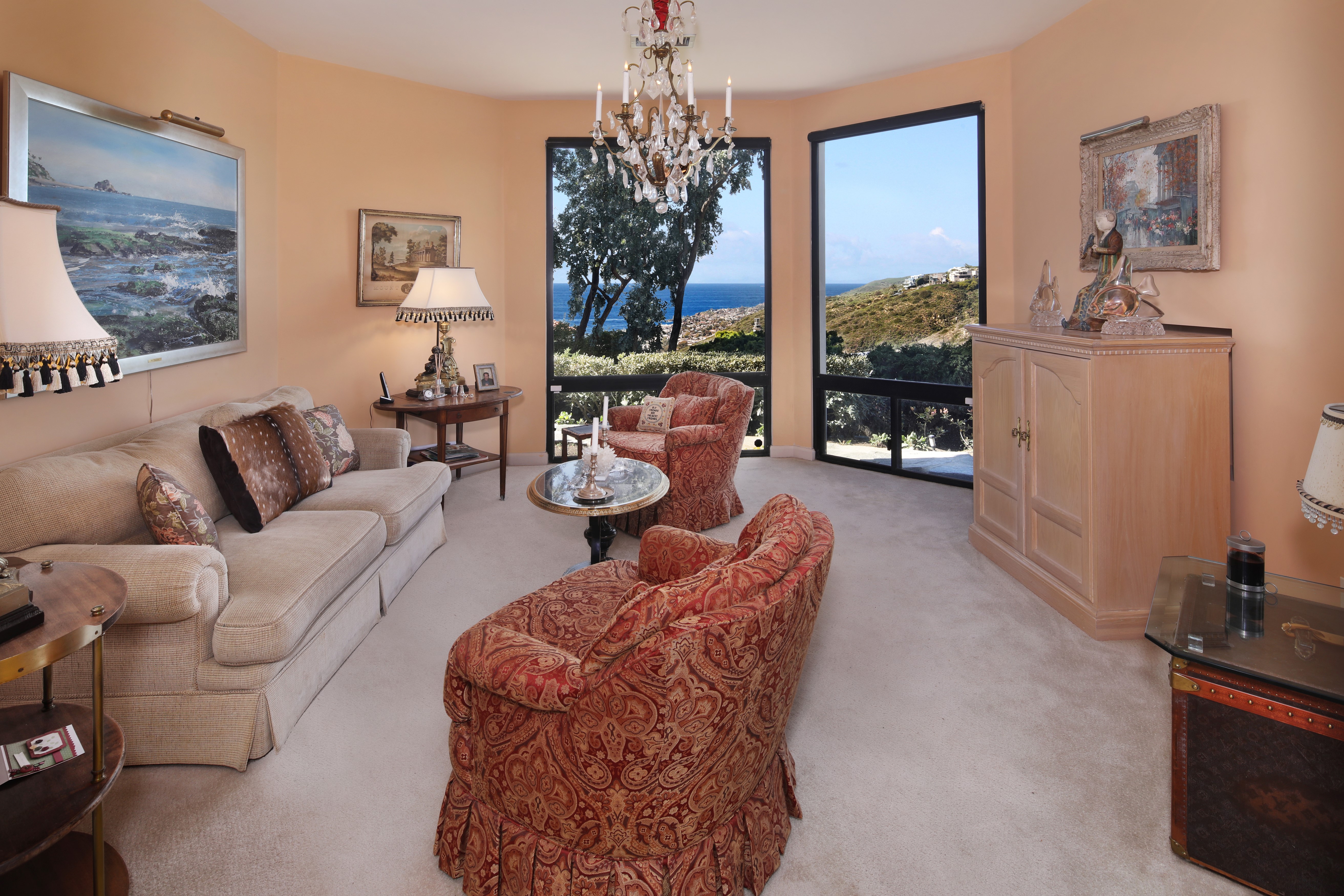 Living room with sofa, armchairs, and ocean view HD Wallpaper