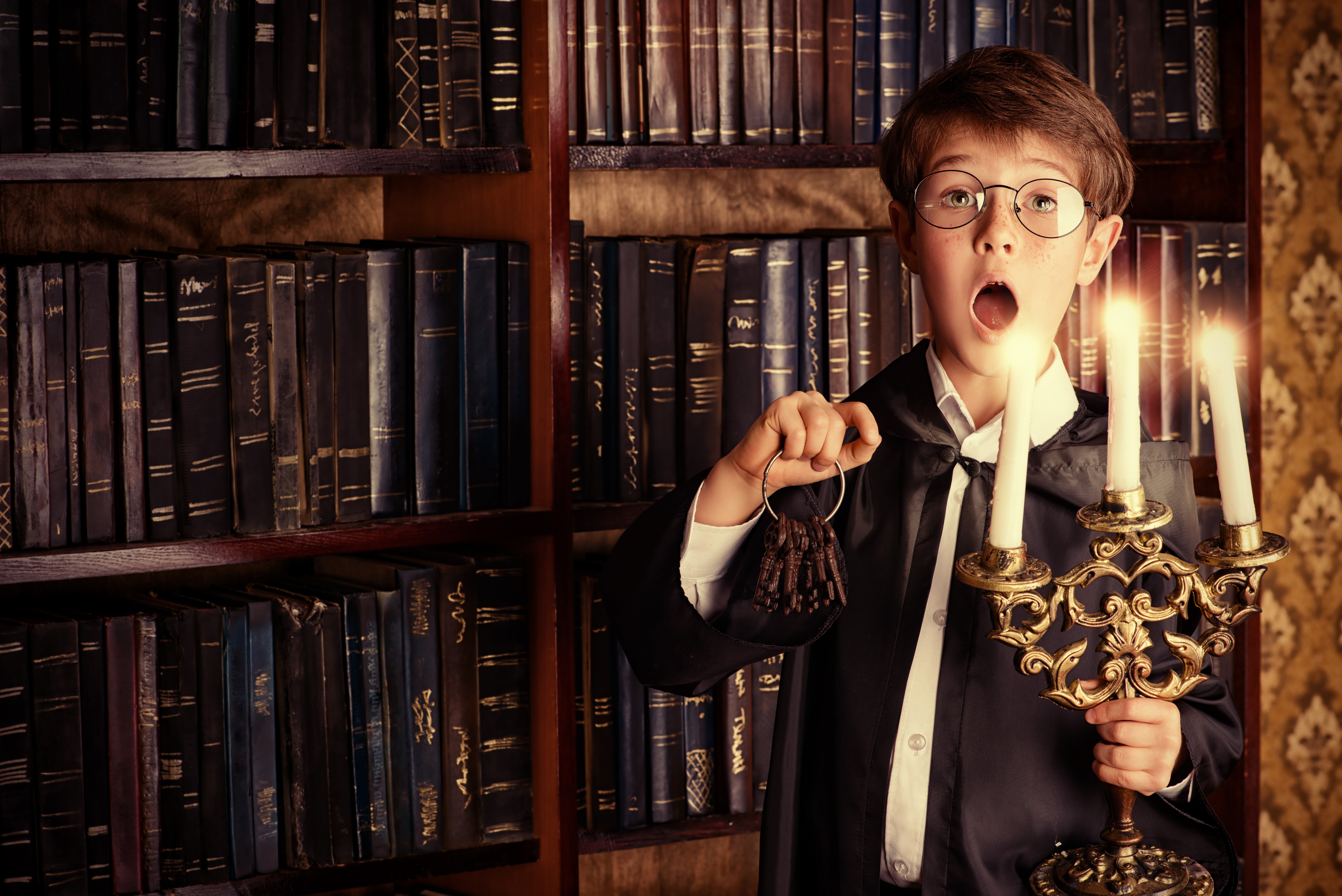 Boy with glasses holding keys and candelabra HD Wallpaper