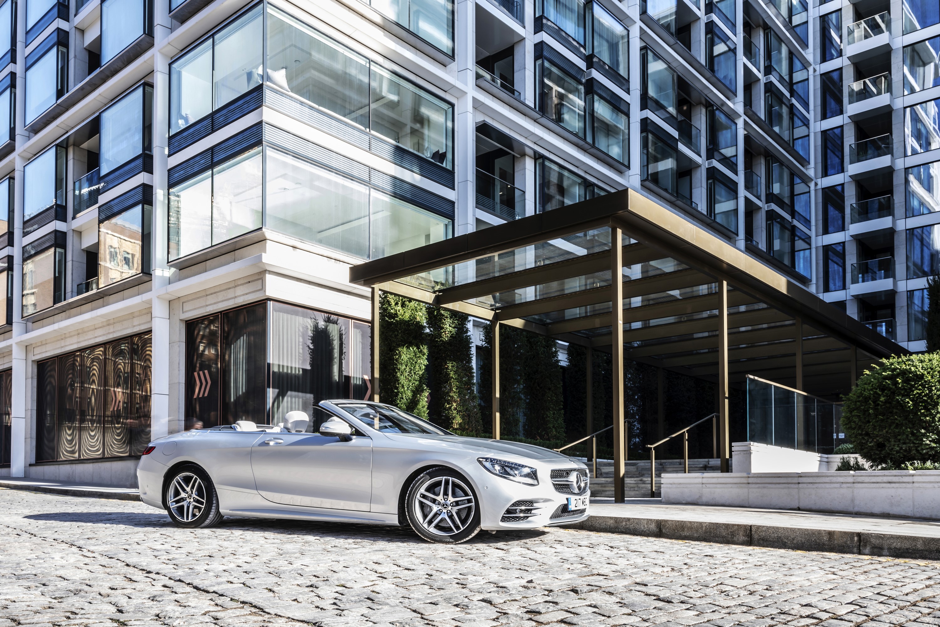 Silver Mercedes-Benz S 560 Cabriolet AMG Line parked on cobblestone street HD Wallpaper