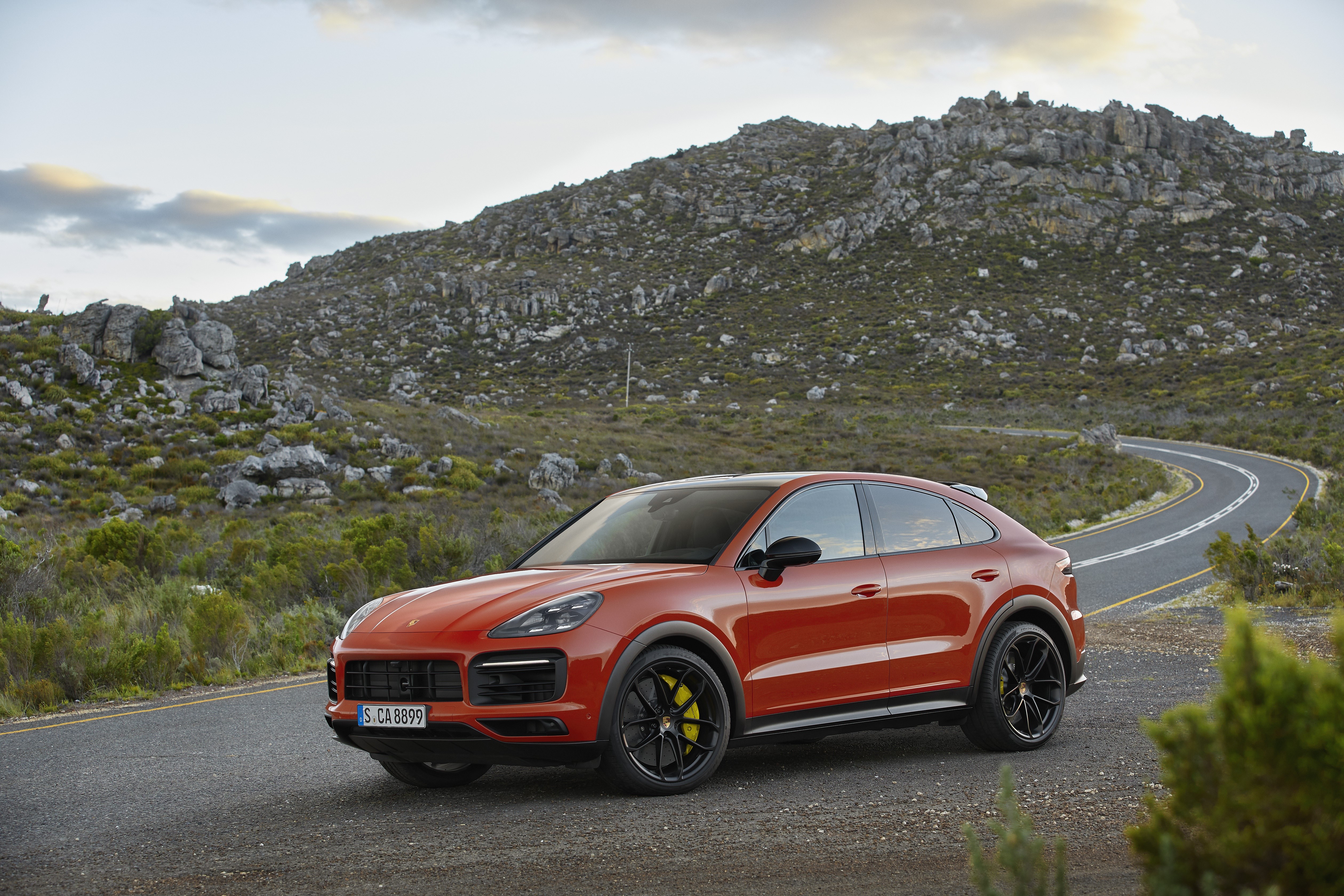 Red Porsche Cayenne Coupe on a Mountain Road HD Wallpaper