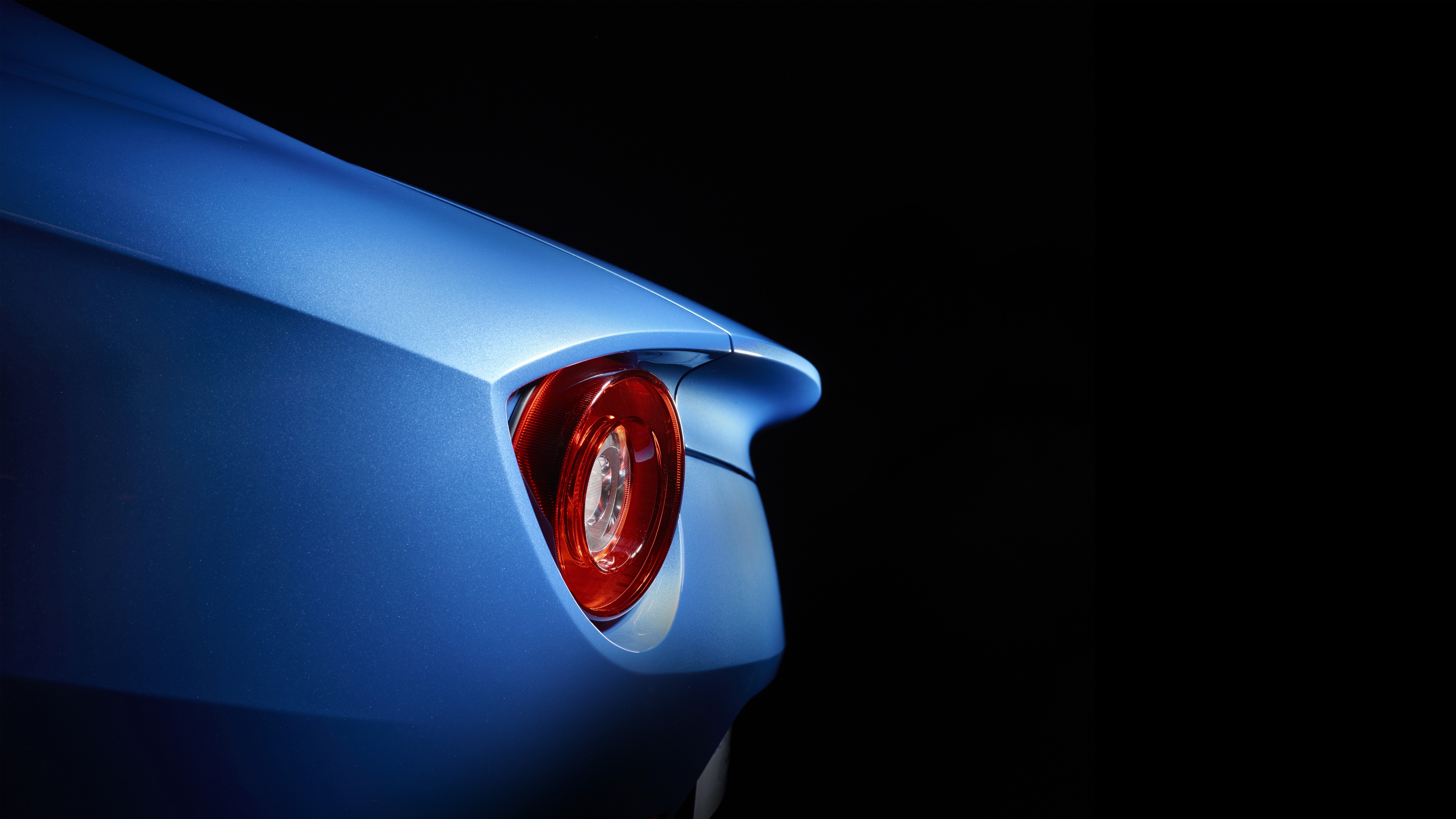 Ferrari F12 Berlinetta taillight on black background HD Wallpaper