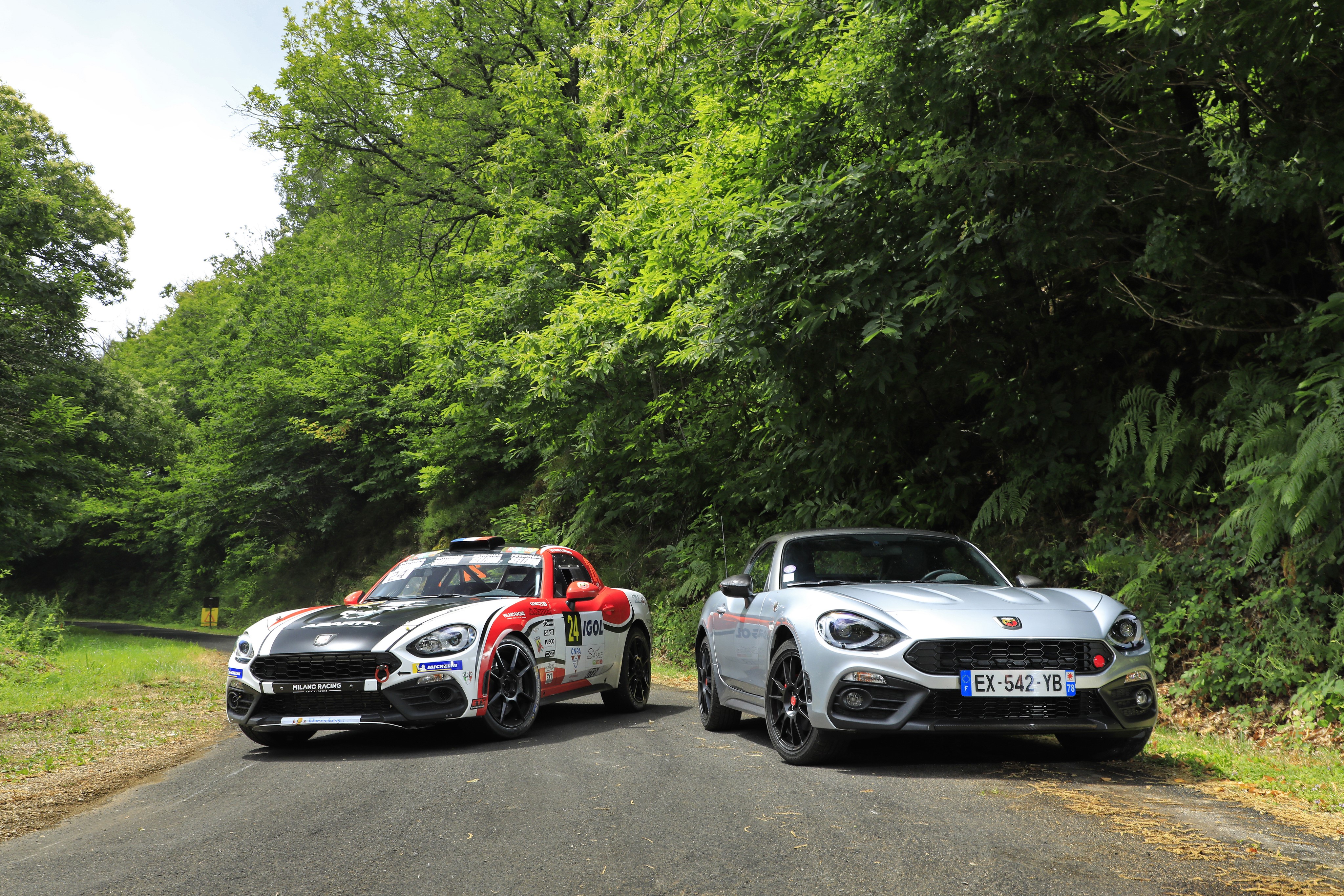 Two Abarth 124 Spider cars on a road HD Wallpaper