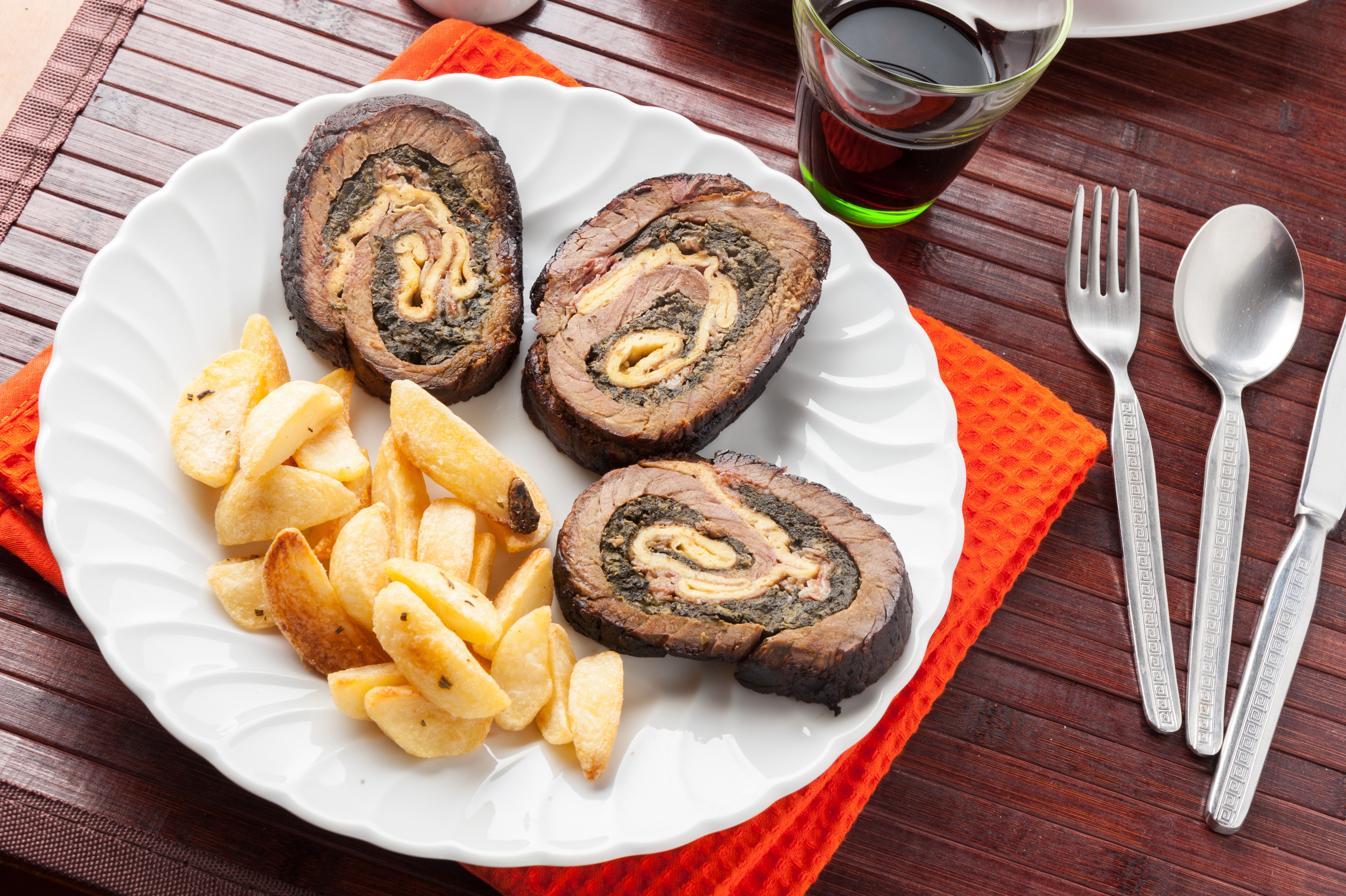 Rolled meat with potato wedges on a plate HD Wallpaper