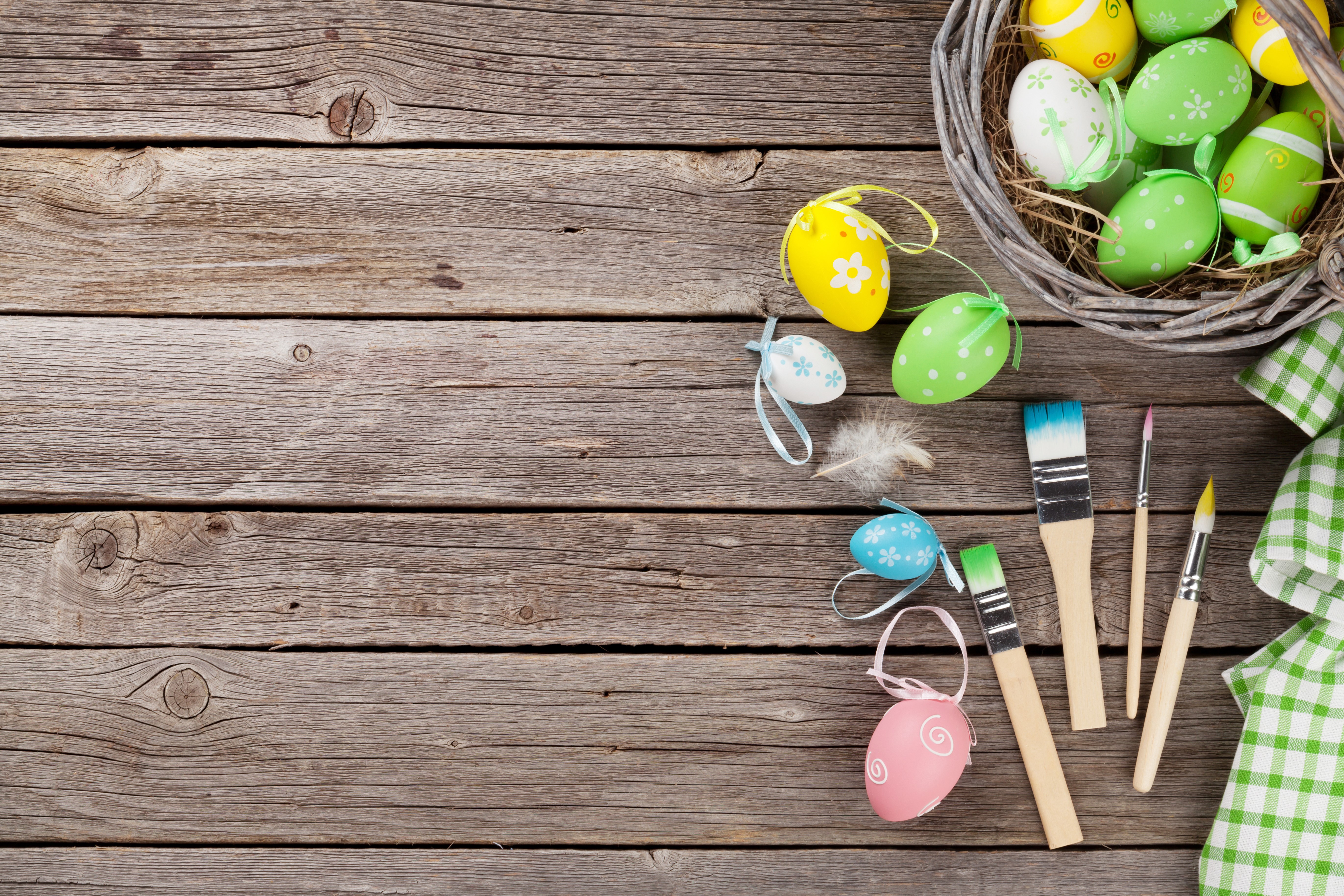Easter eggs and paintbrushes on wood planks HD Wallpaper
