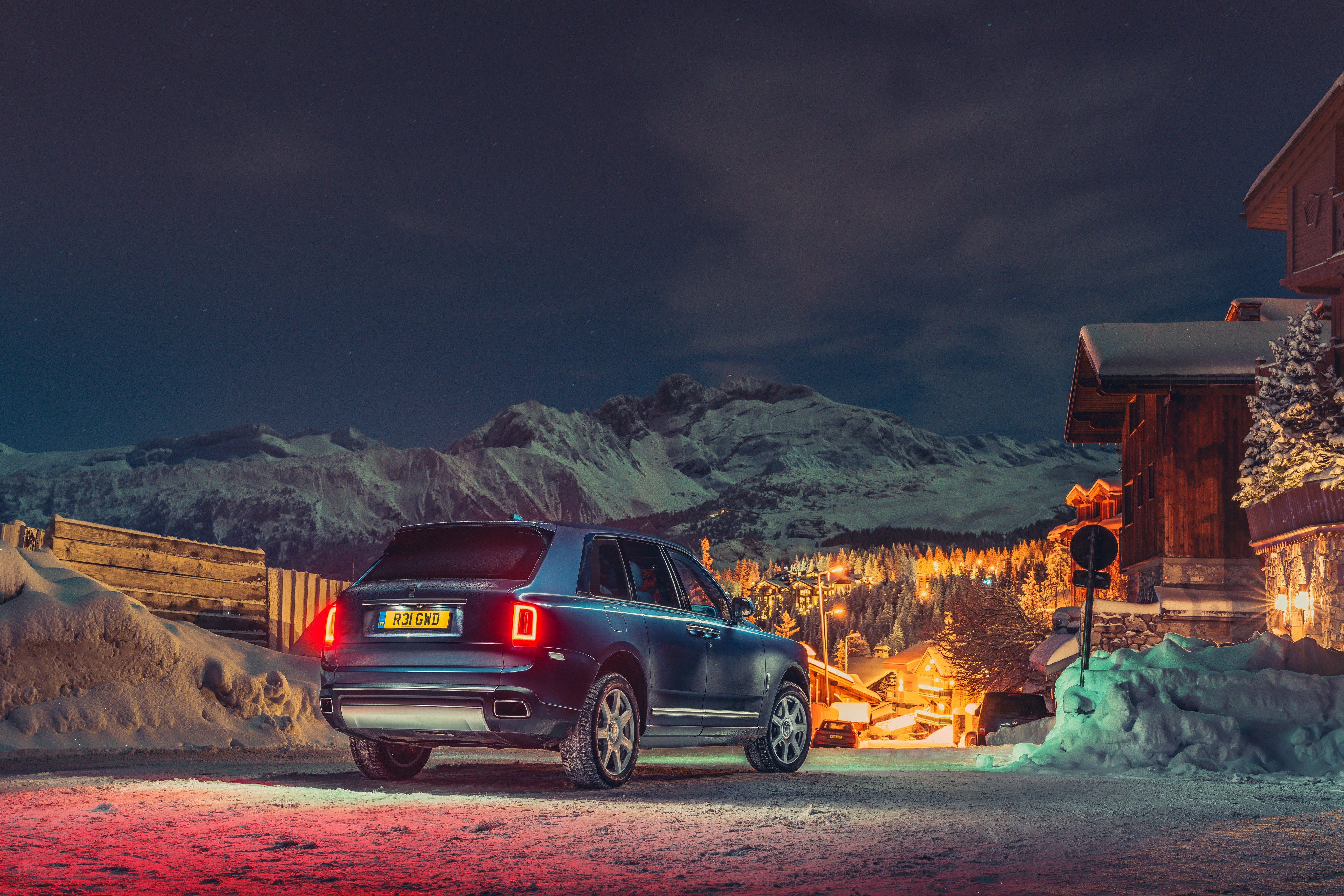 Rolls-Royce Cullinan in snowy mountains at night HD Wallpaper