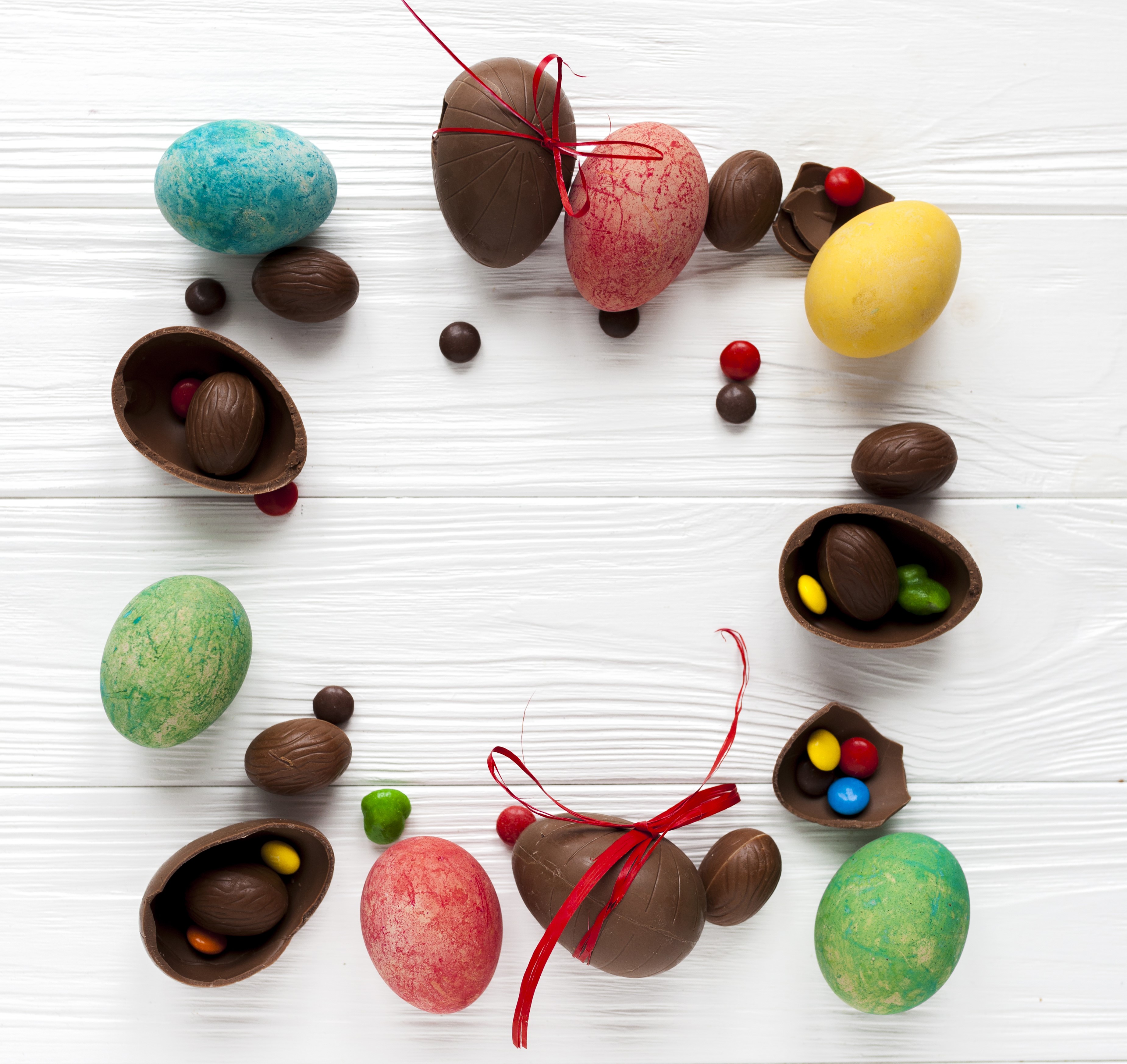Easter chocolate eggs and candies on wood planks HD Wallpaper