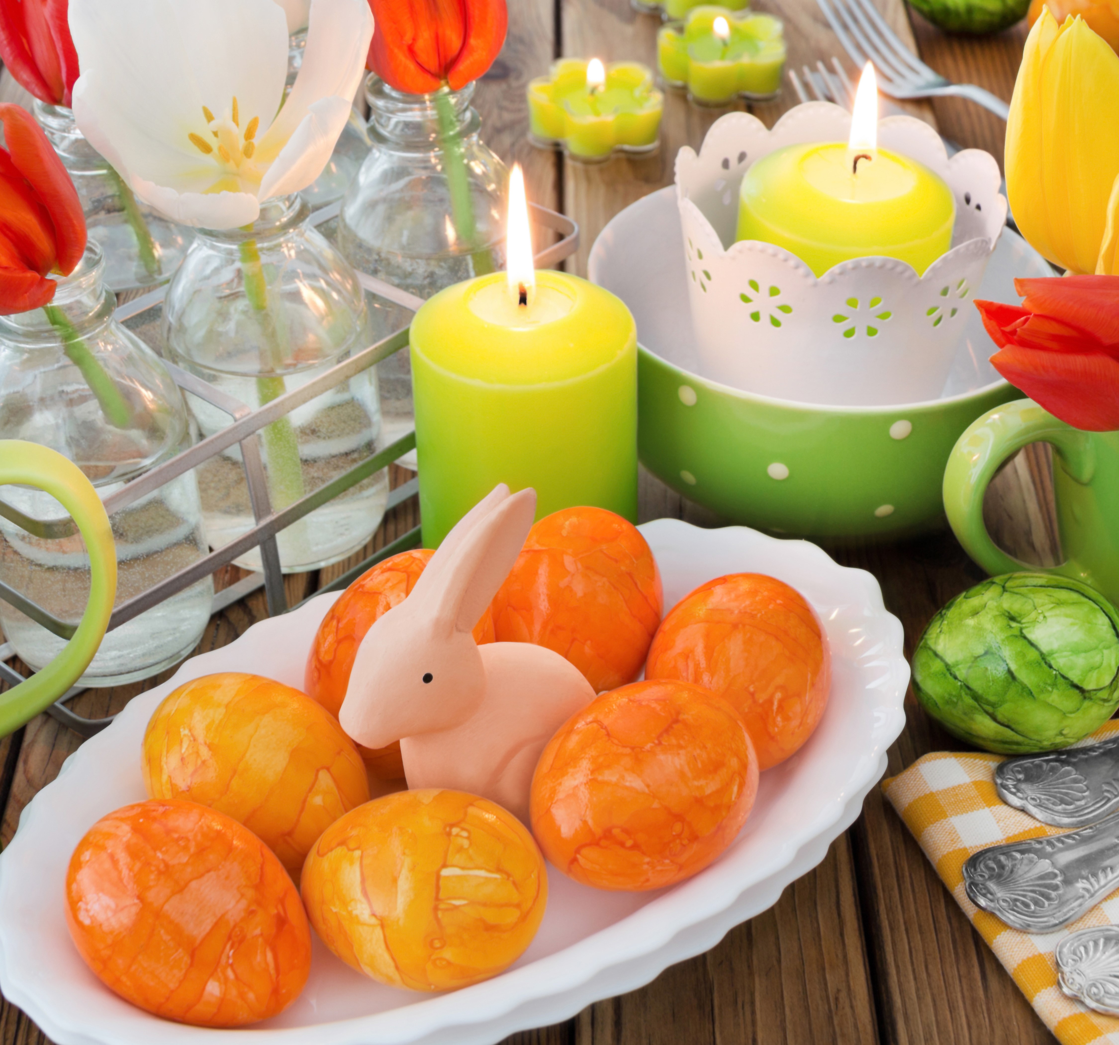 Easter table setting with tulips, candles, and eggs HD Wallpaper