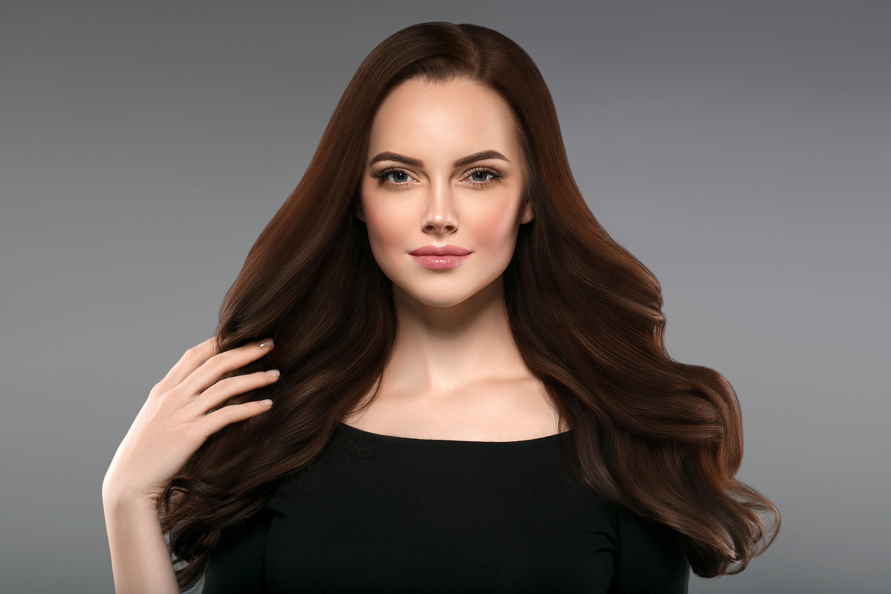 Brown haired woman with hand on hair HD Wallpaper