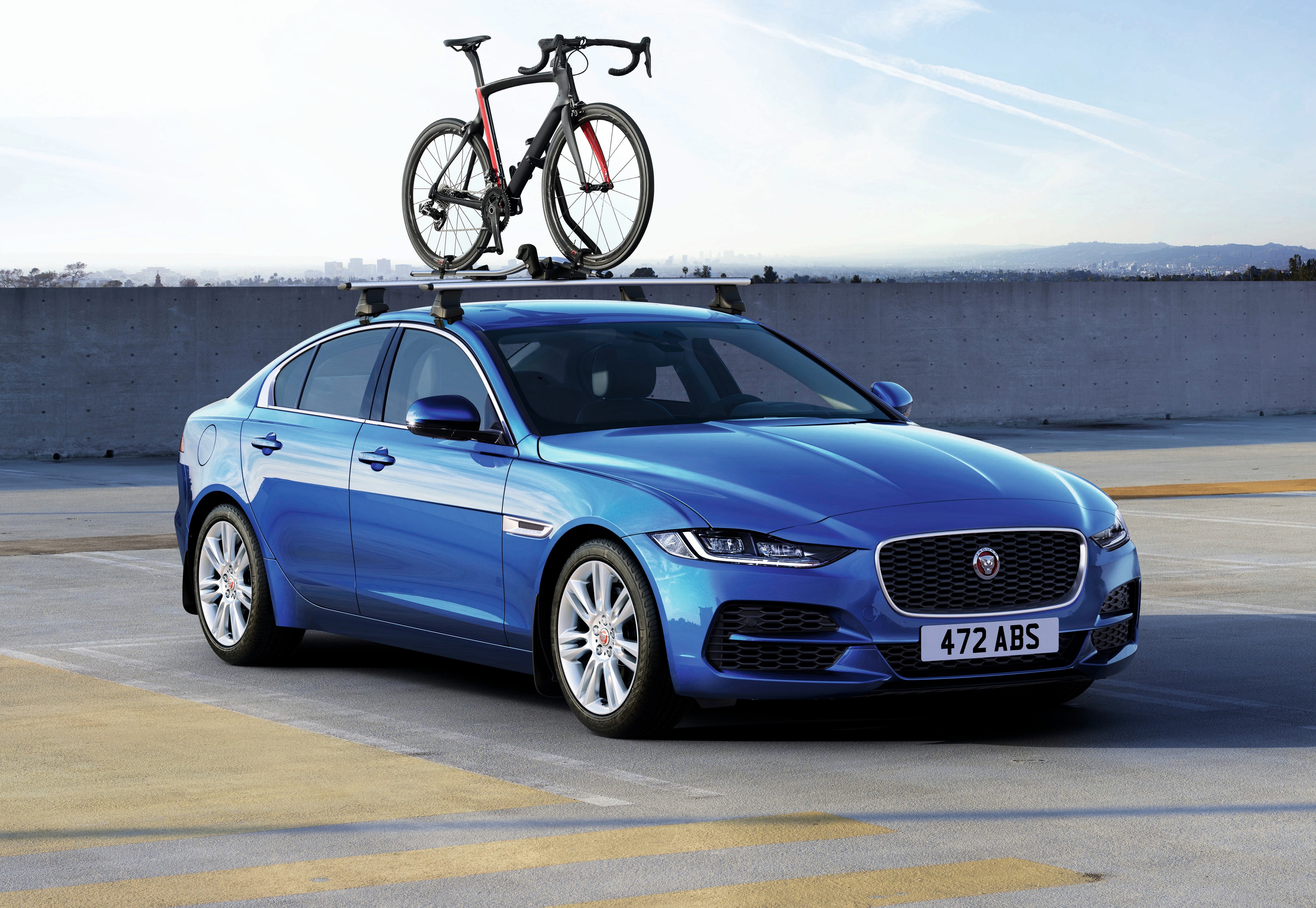 Blue Jaguar XE with Bicycle on Roof Rack HD Wallpaper