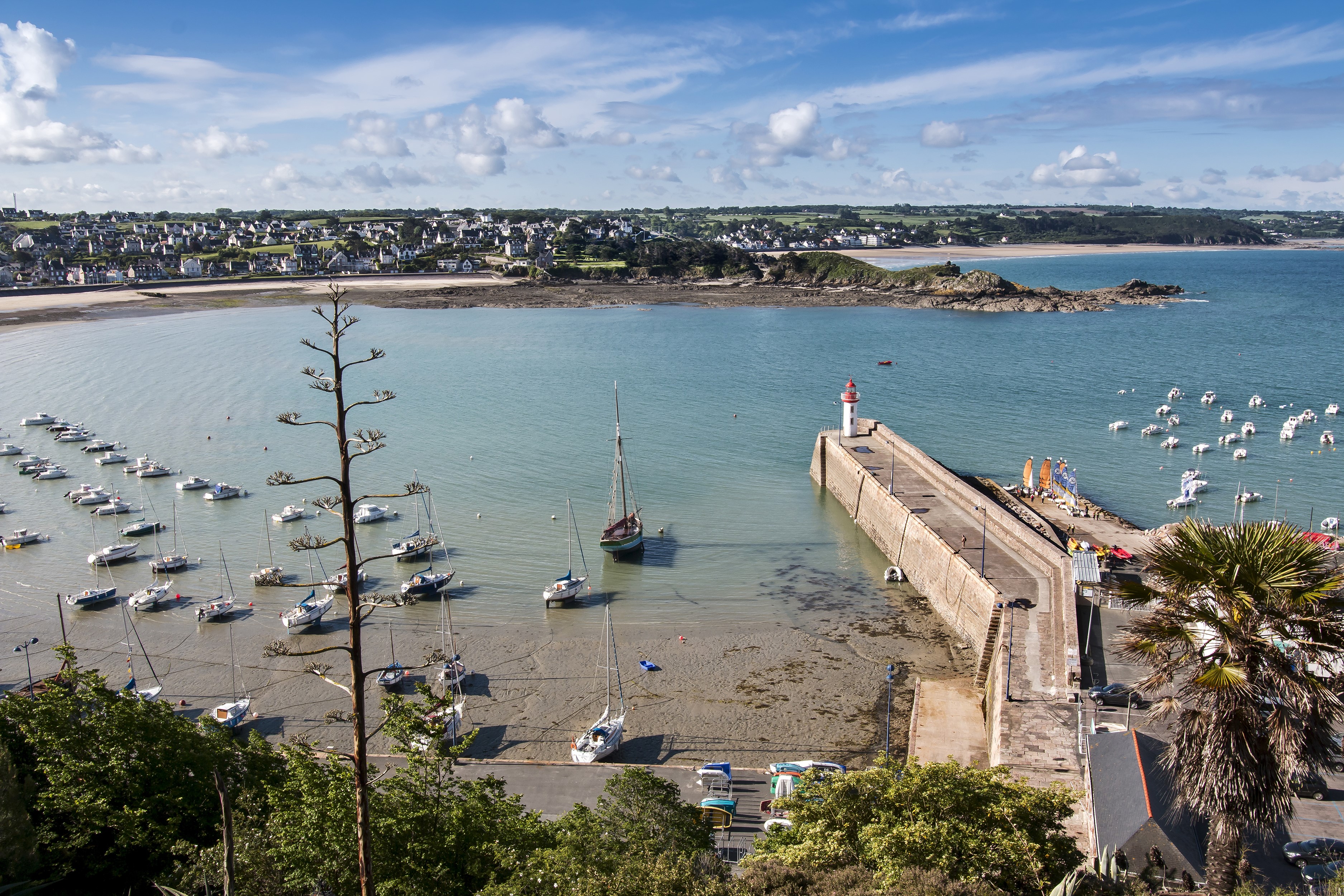 Boats in a bay with a lighthouse in Erquy, Brittany, France HD Wallpaper