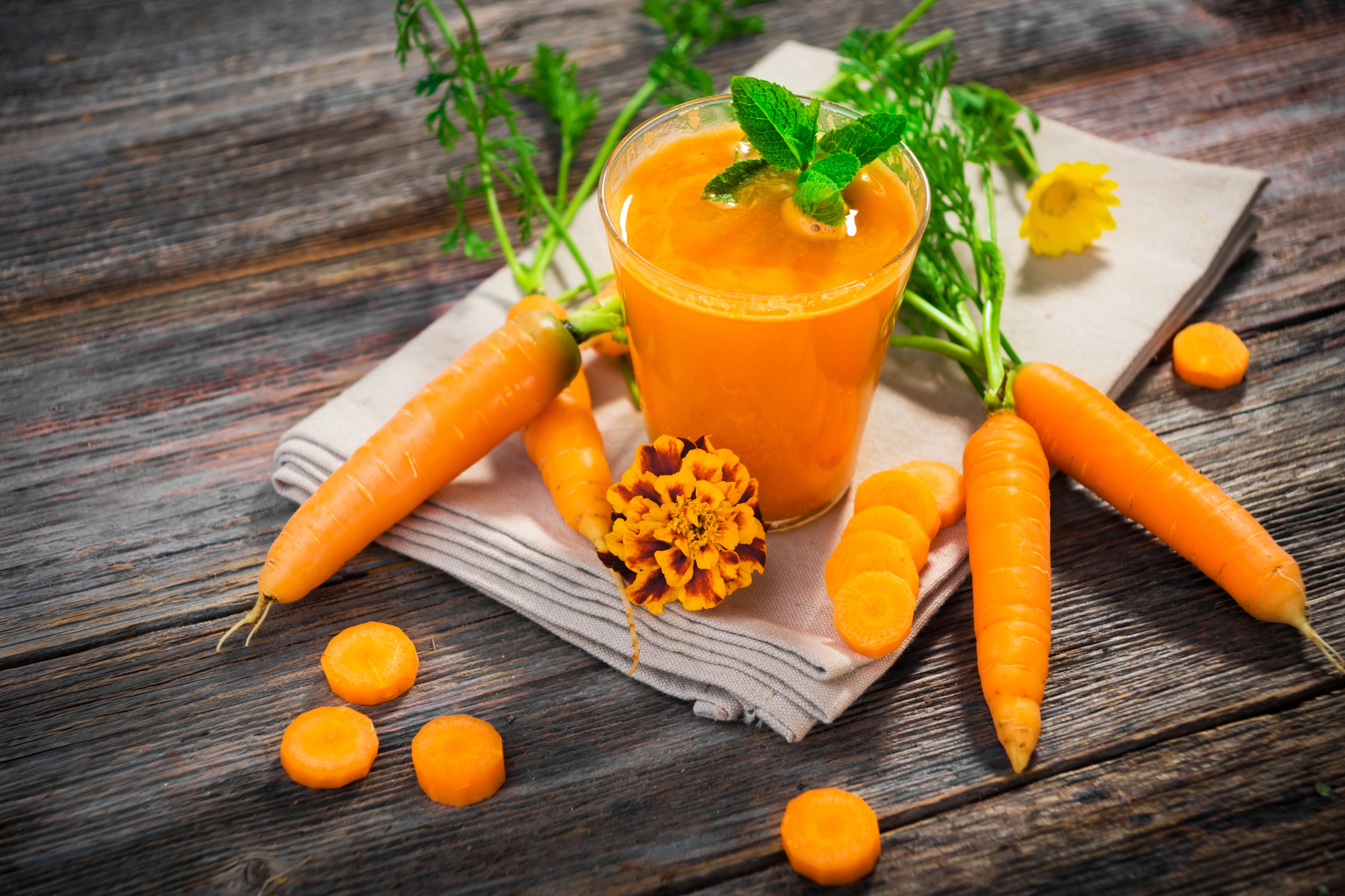 Carrot juice in a glass with fresh carrots HD Wallpaper