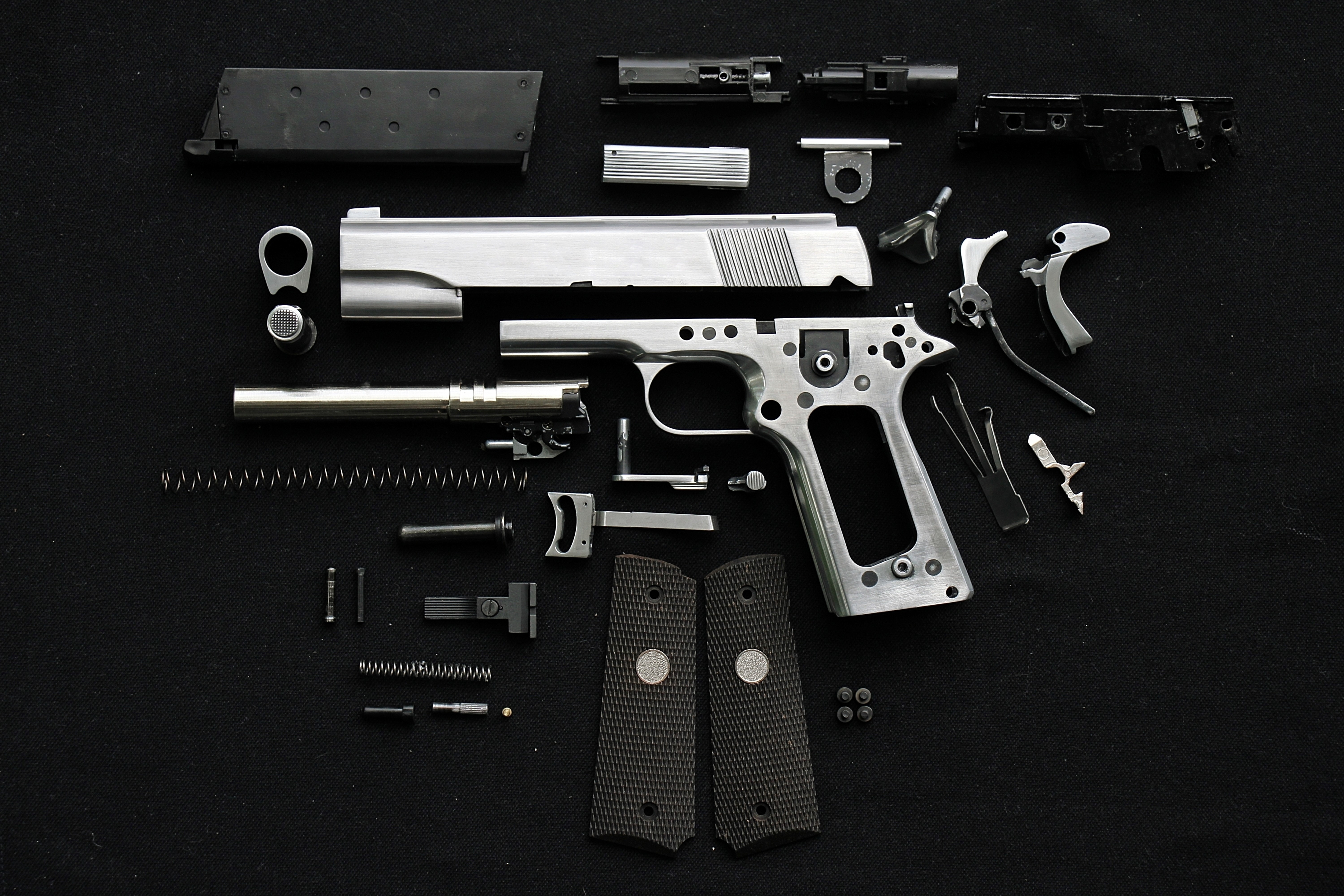 Disassembled Pistol on Black Background HD Wallpaper