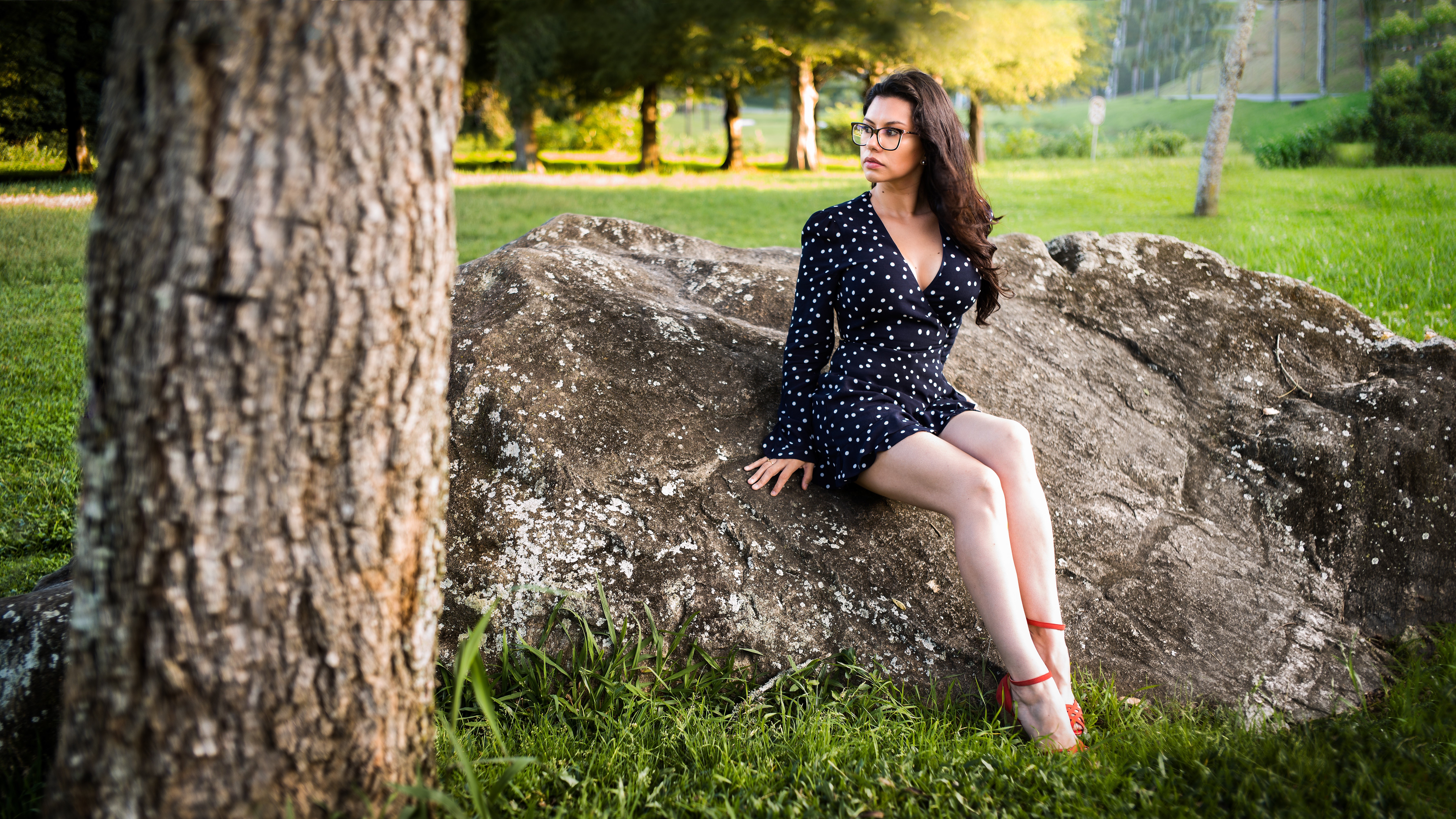 Woman in polka dot dress sitting on a rock HD Wallpaper