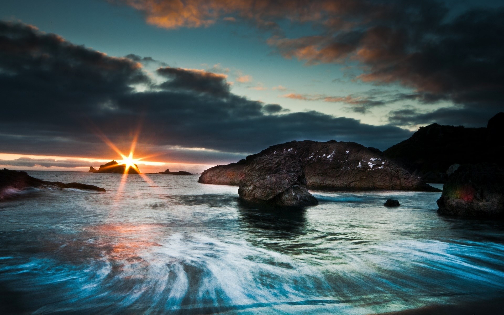 Sunset over rocky coast with ocean waves HD Wallpaper