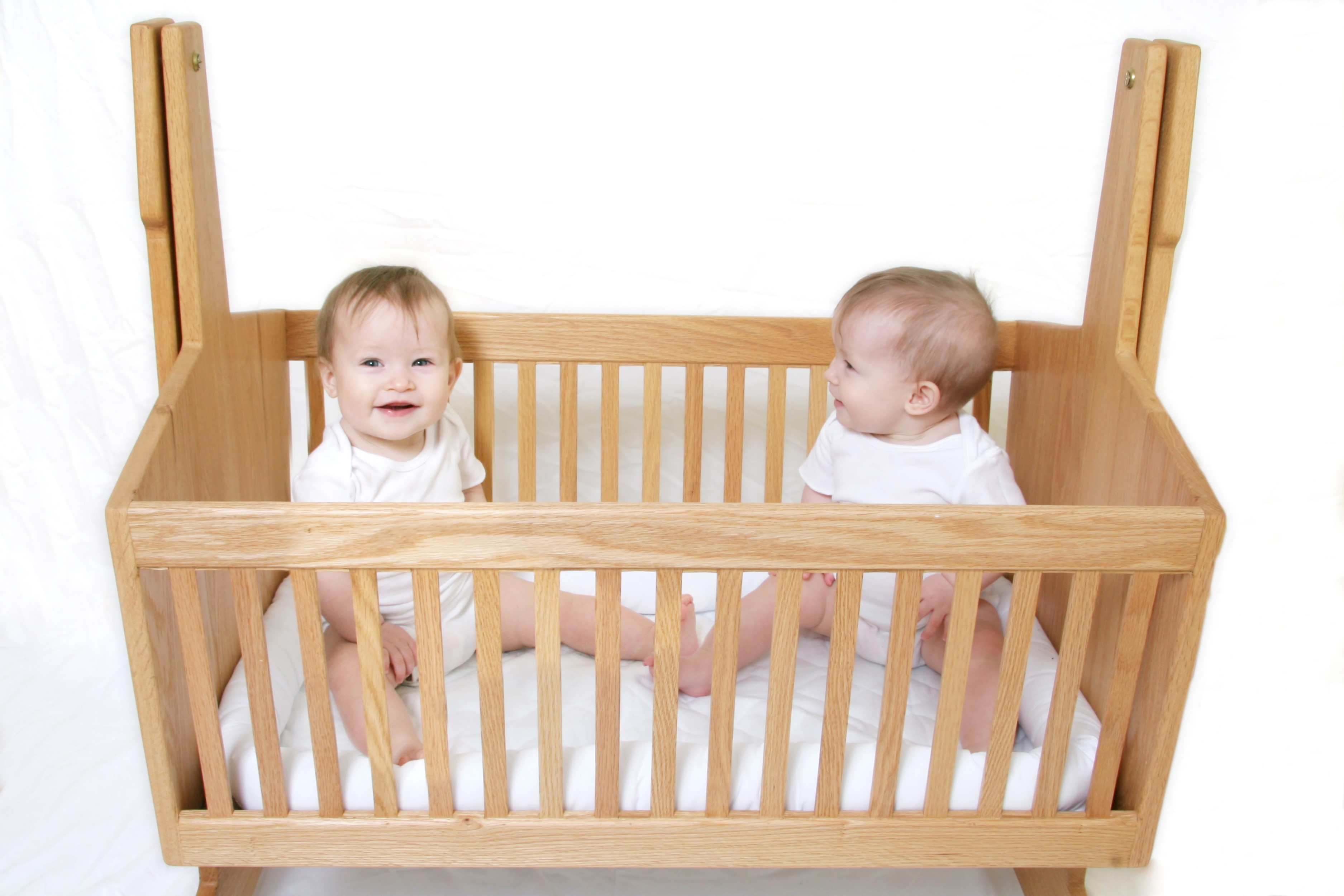 Two babies in a wooden crib HD Wallpaper