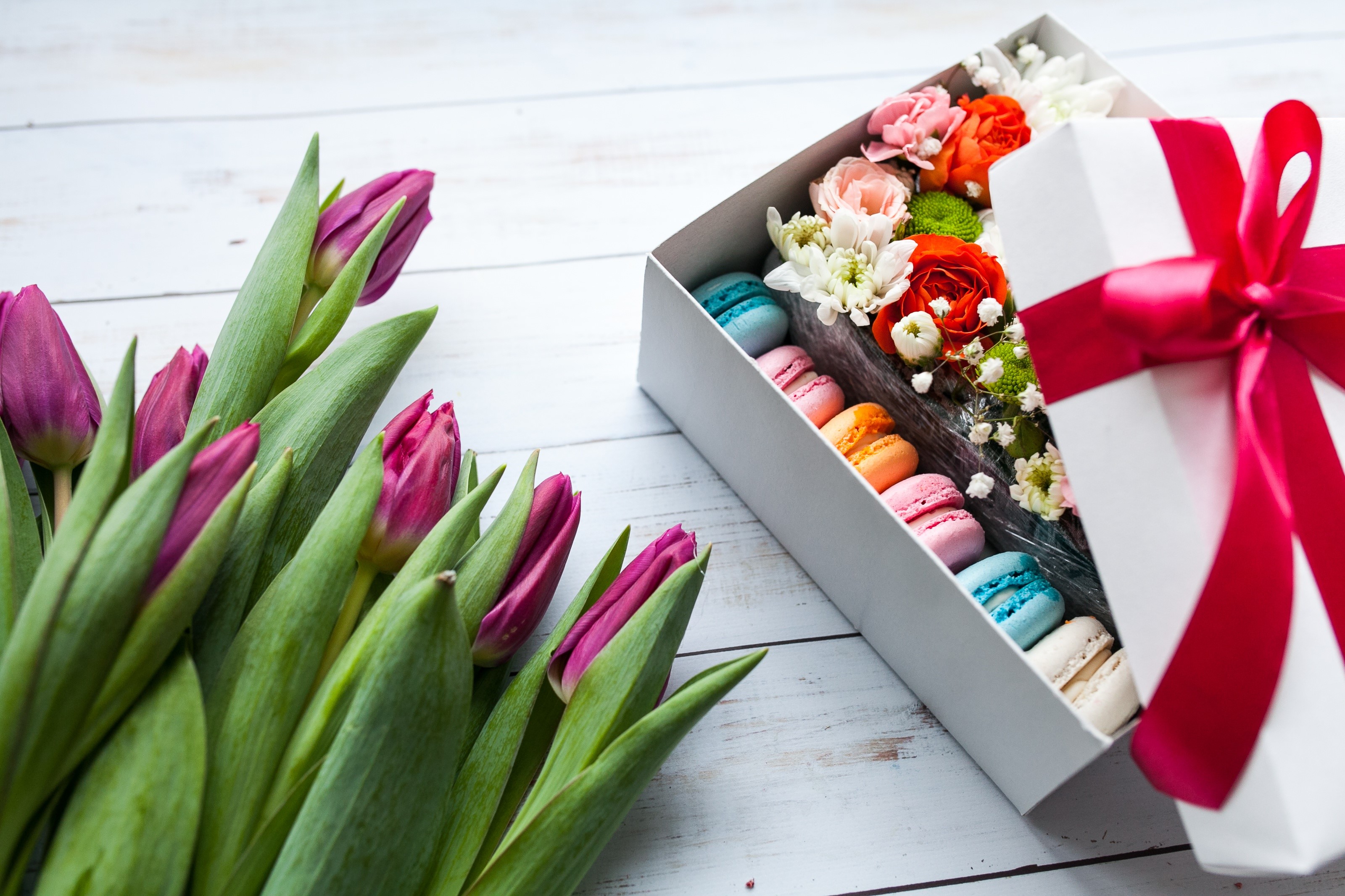 Tulips and macarons in a gift box with a red bow HD Wallpaper