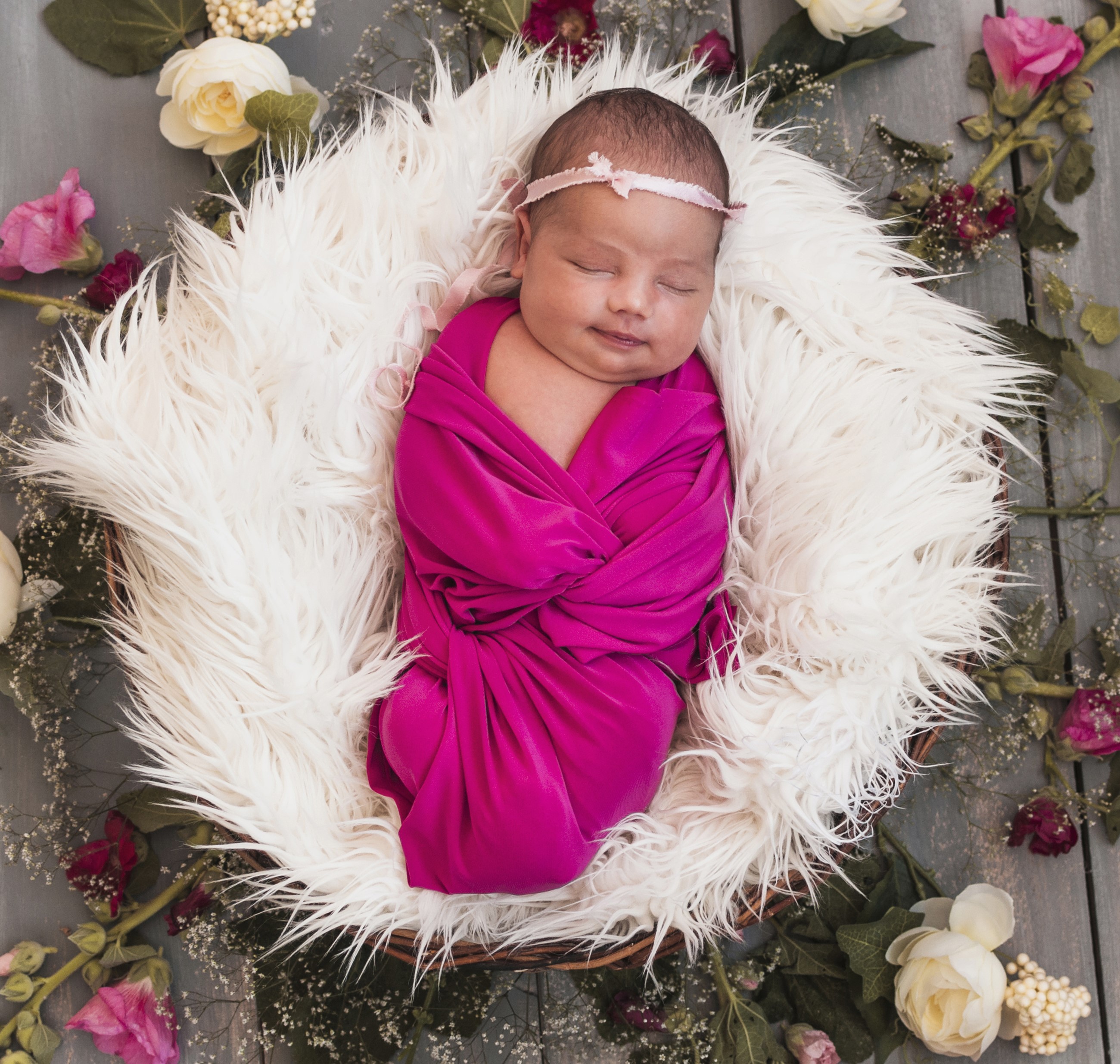 Newborn baby girl sleeping in a basket with flowers HD Wallpaper