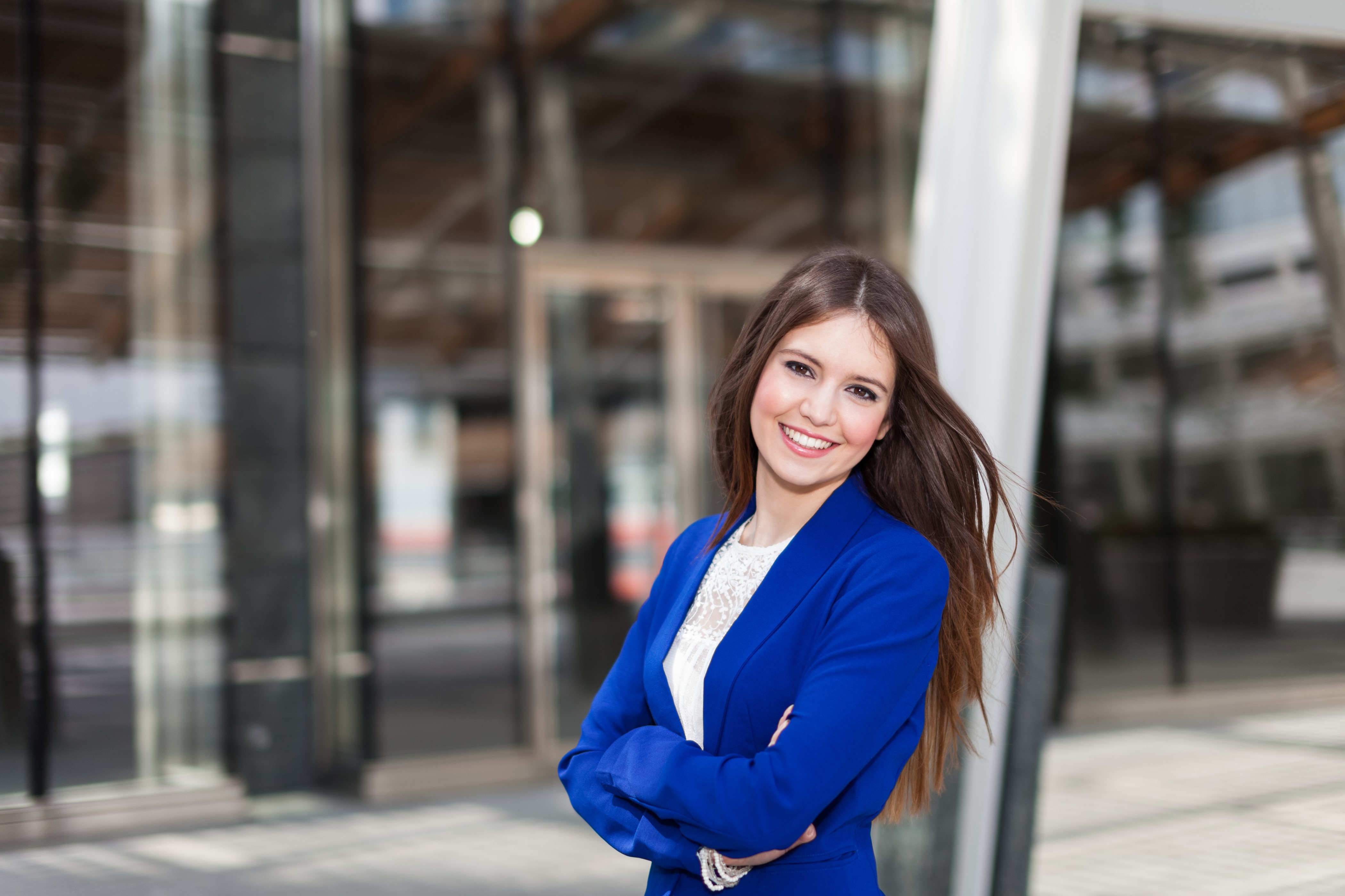 Brown haired woman smiling in blue blazer HD Wallpaper