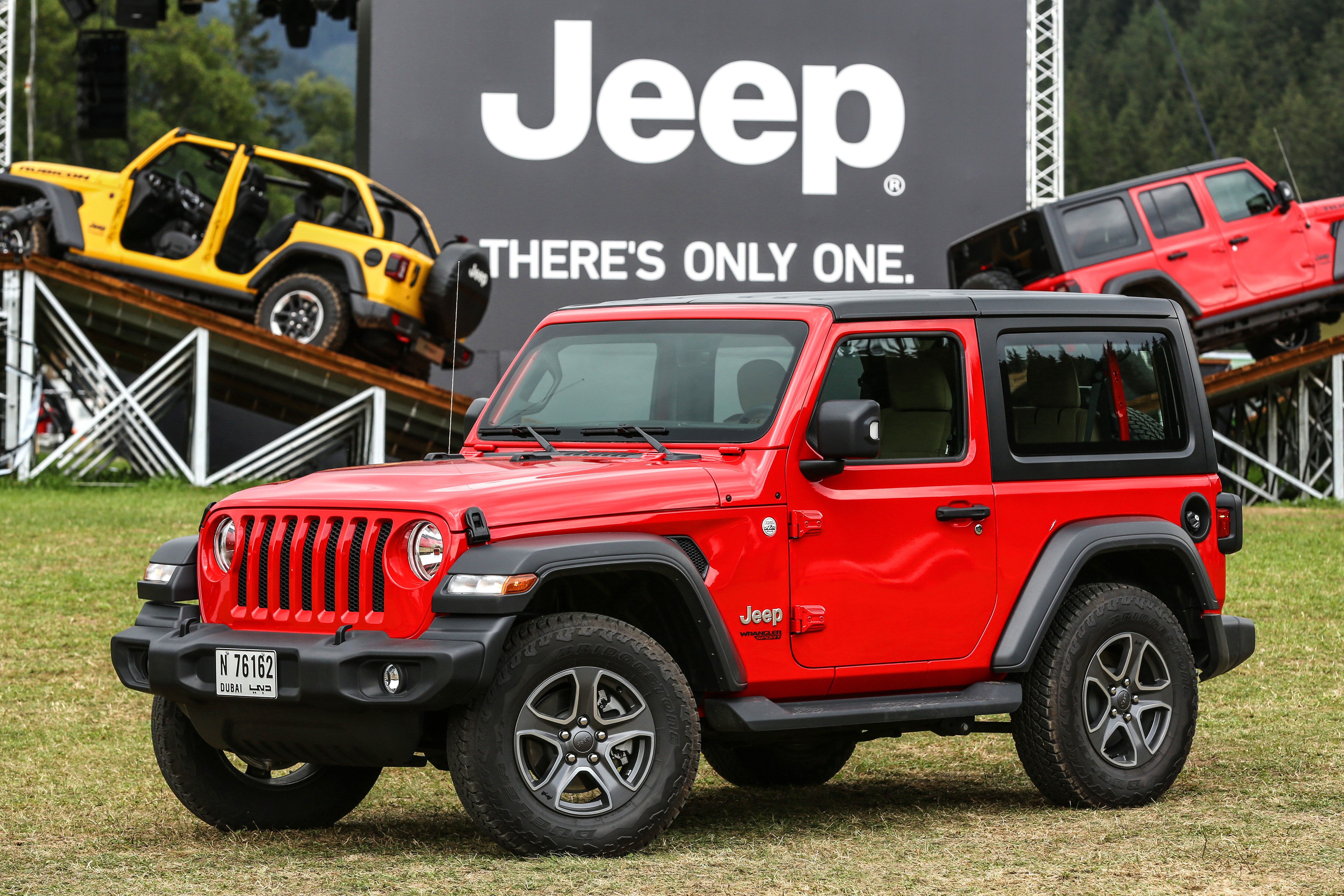 Red Jeep Wrangler with Jeep branding HD Wallpaper
