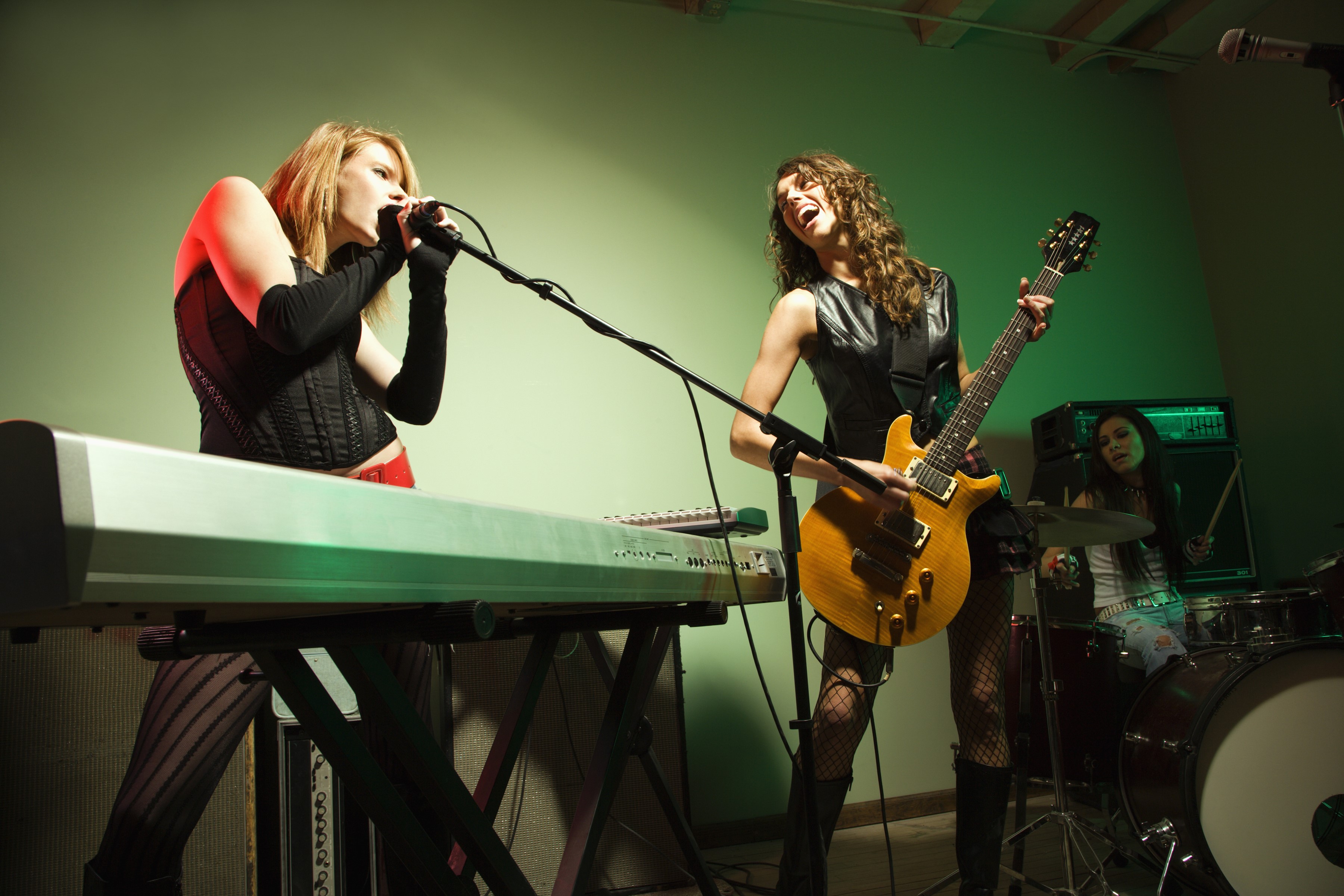 Three women performing music on stage HD Wallpaper