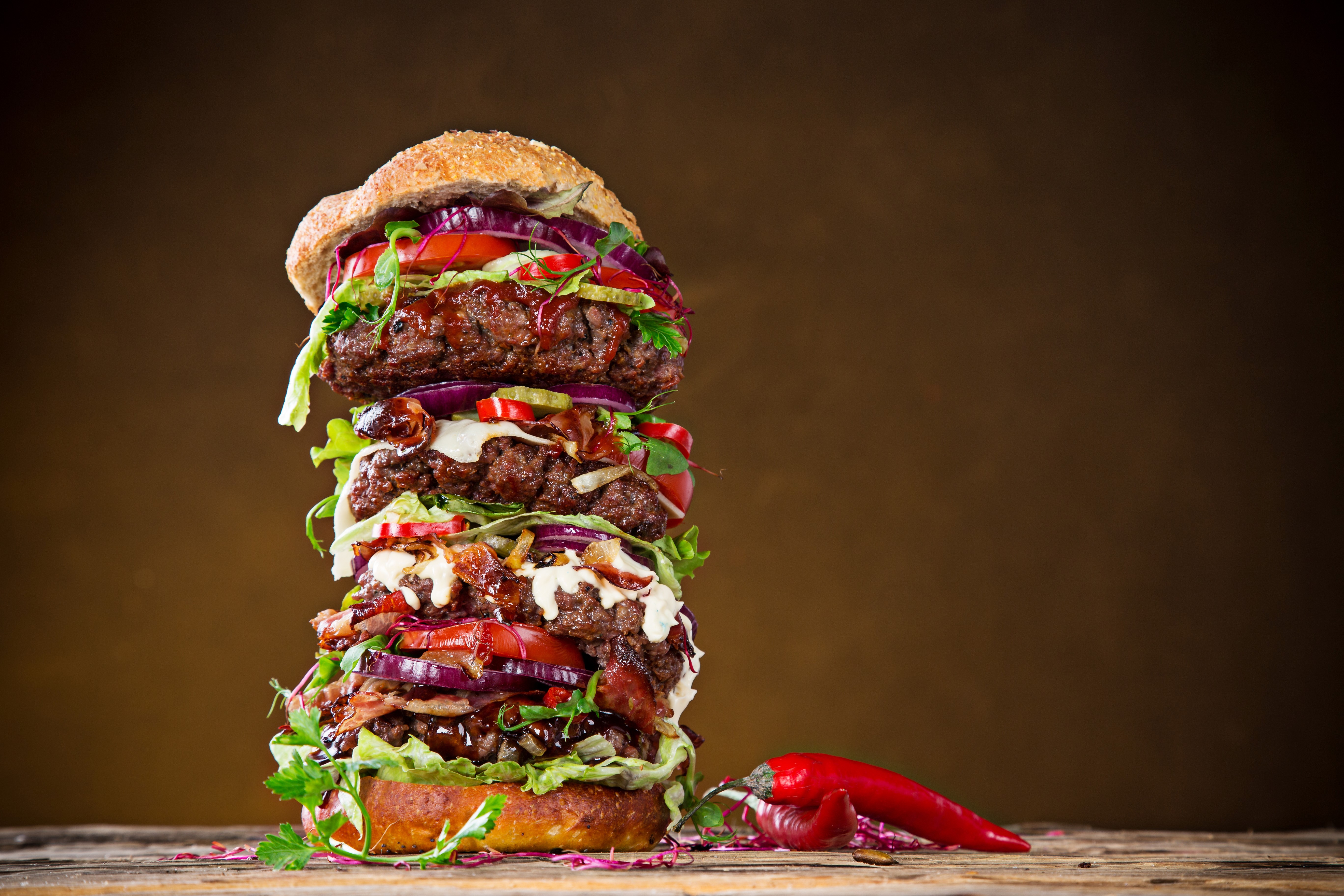 Giant stacked hamburger with chili peppers HD Wallpaper
