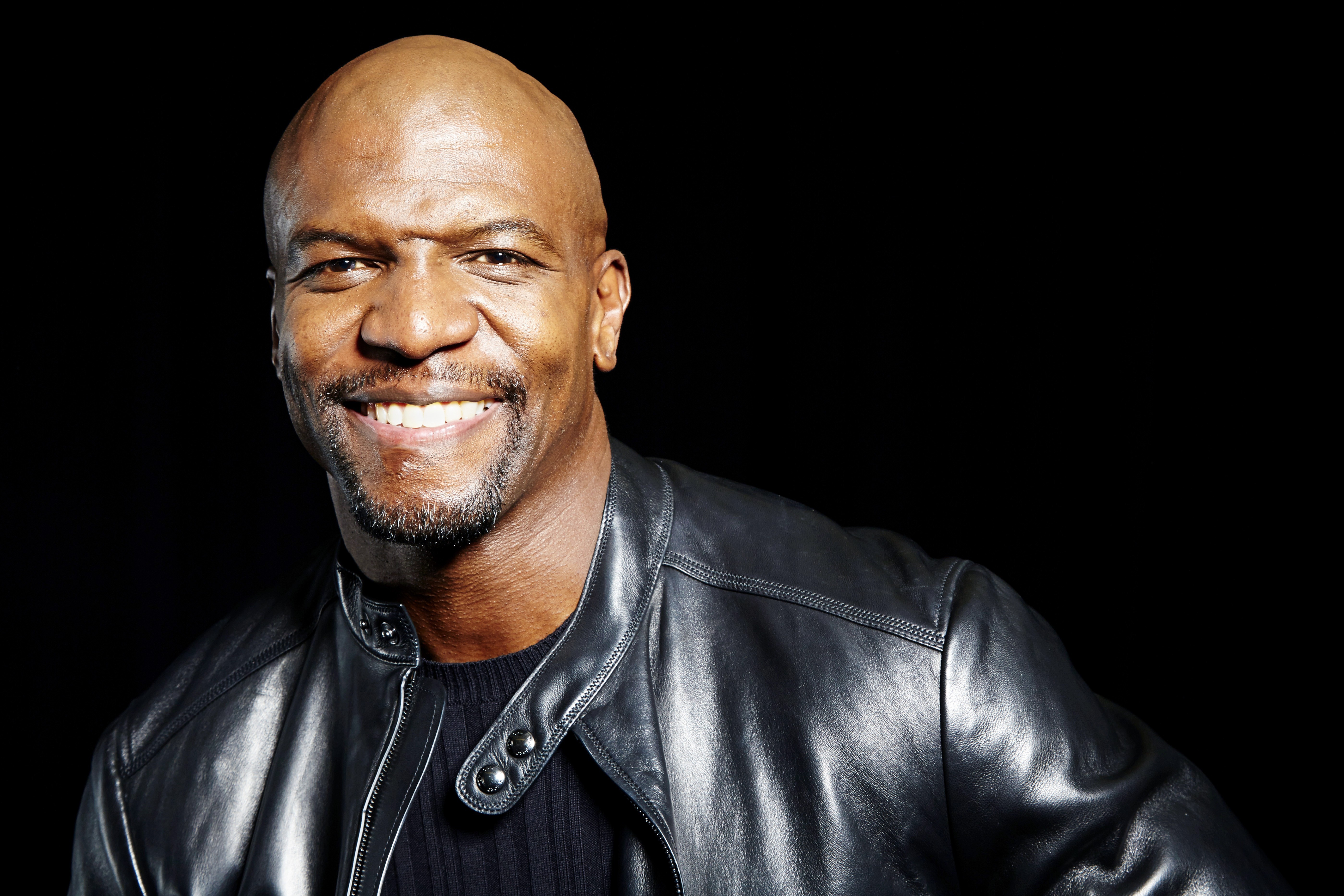 Terry Crews smiling, wearing a leather jacket HD Wallpaper