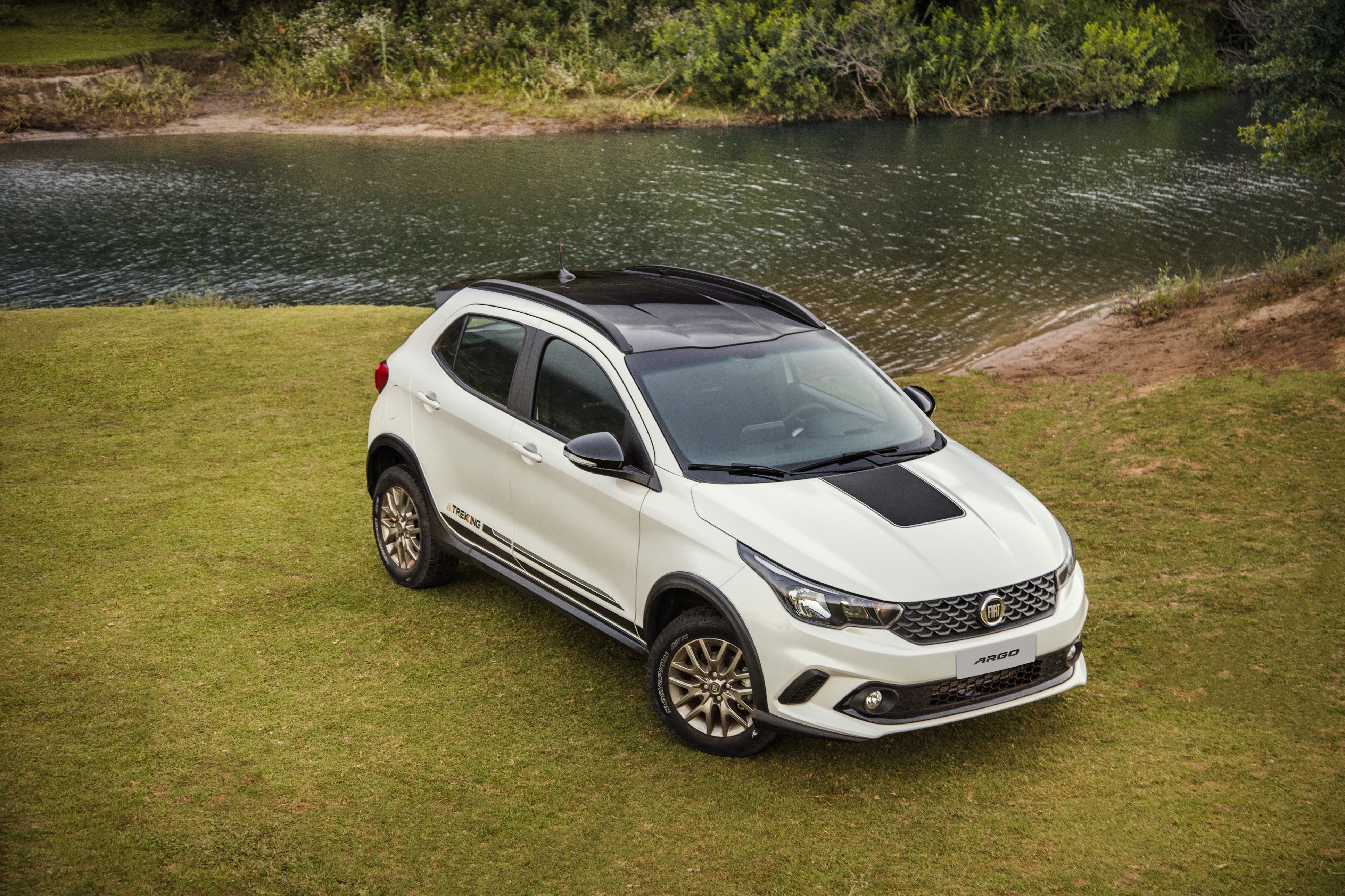 White Fiat Argo Trekking parked on grass by a river HD Wallpaper