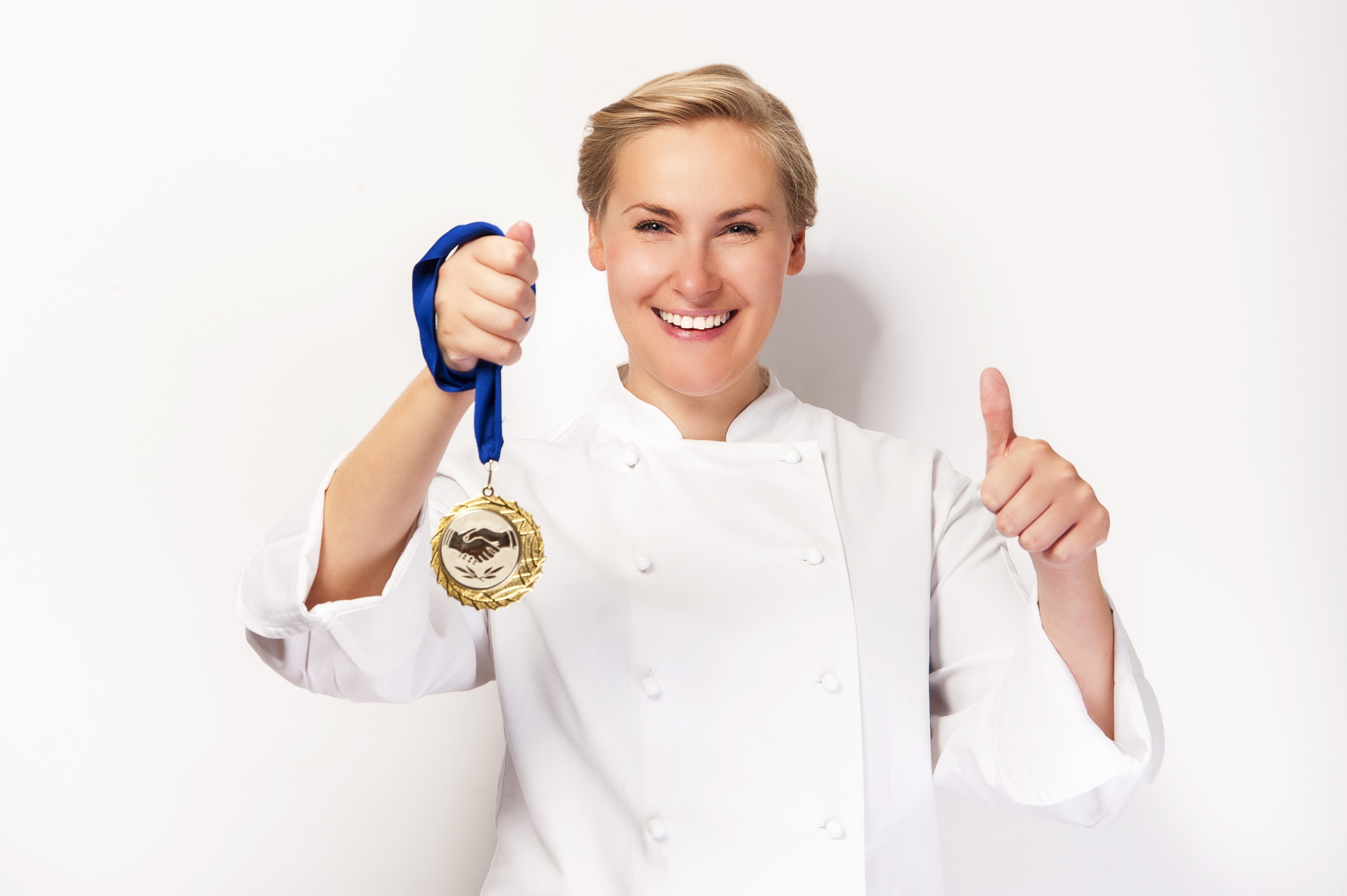 Chef holding a medal and giving a thumbs up HD Wallpaper