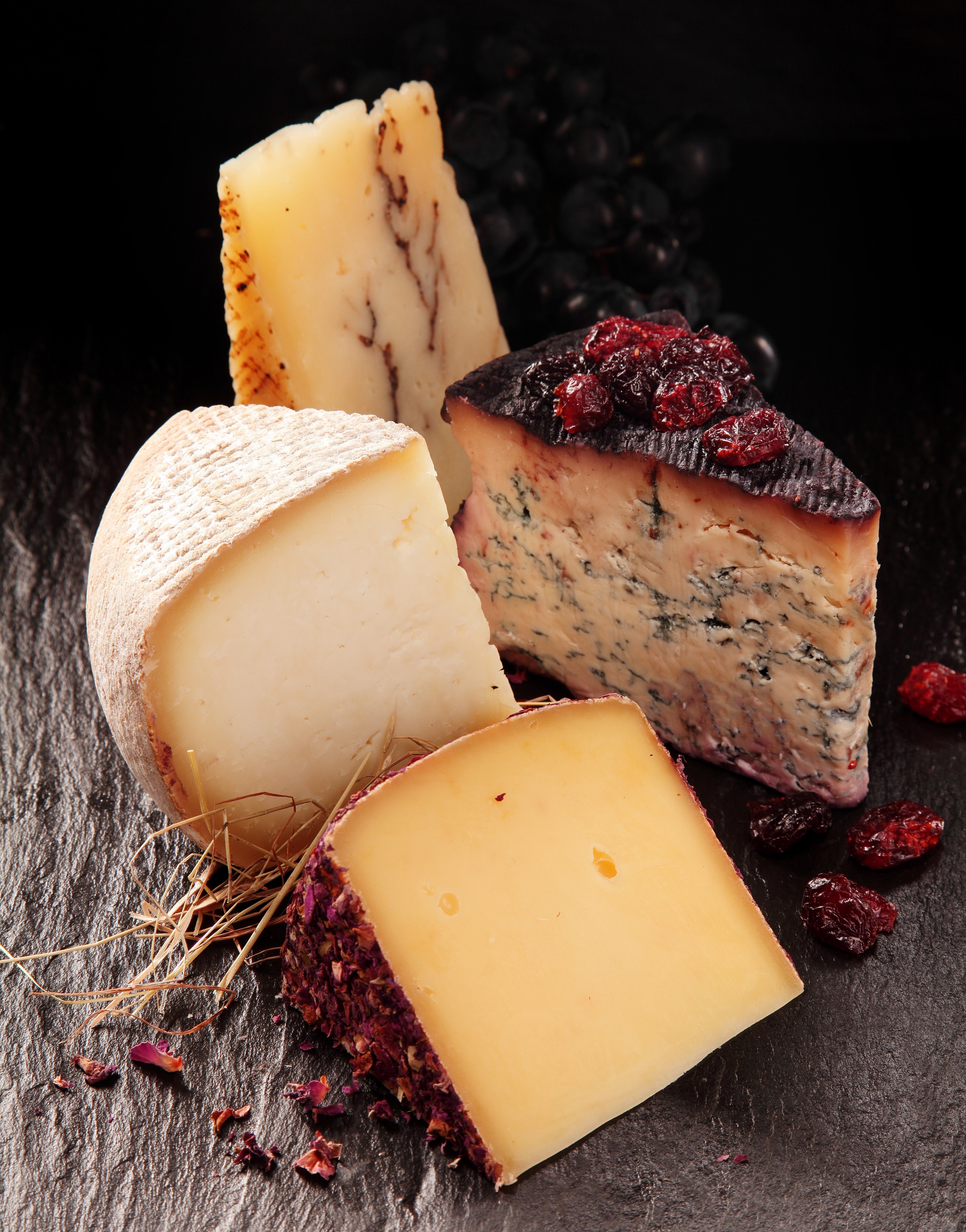 Assortment of artisanal cheeses with dried cranberries and grapes HD Phone Wallpaper