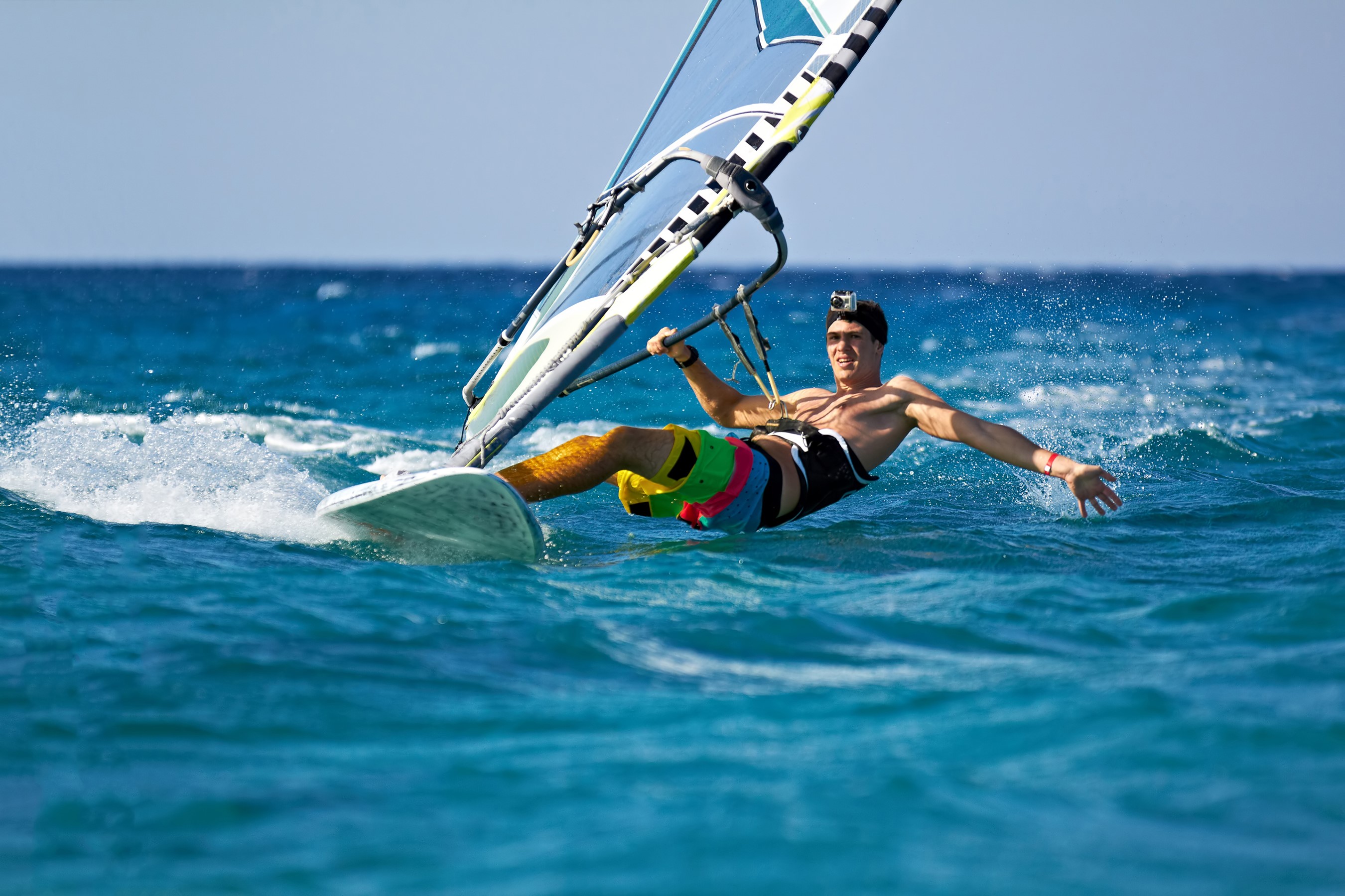 Man windsurfing on a sunny day HD Wallpaper