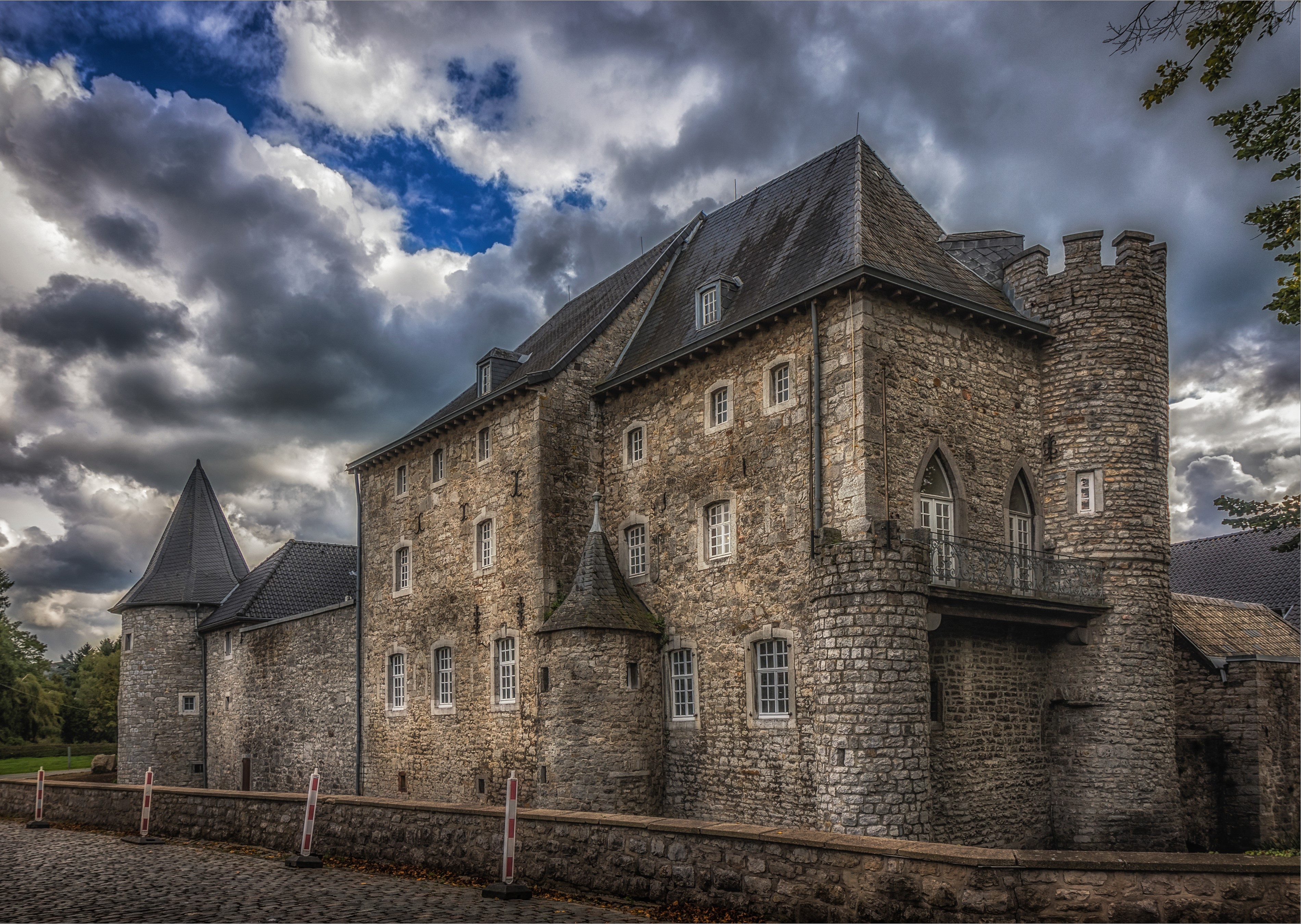 Castle in Raeren, Belgium under a cloudy sky HD Wallpaper