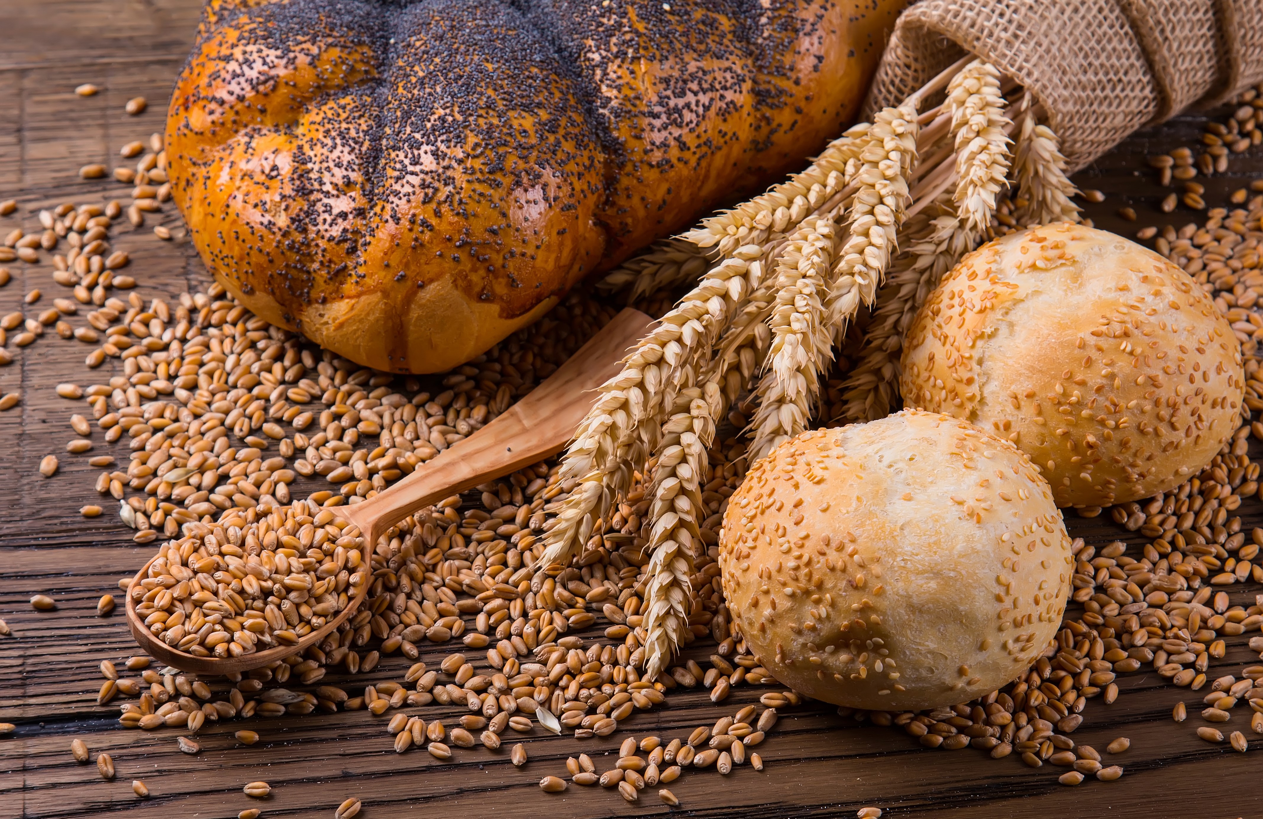 Bread, Buns, Wheat, and Grains on a Wooden Table HD Wallpaper